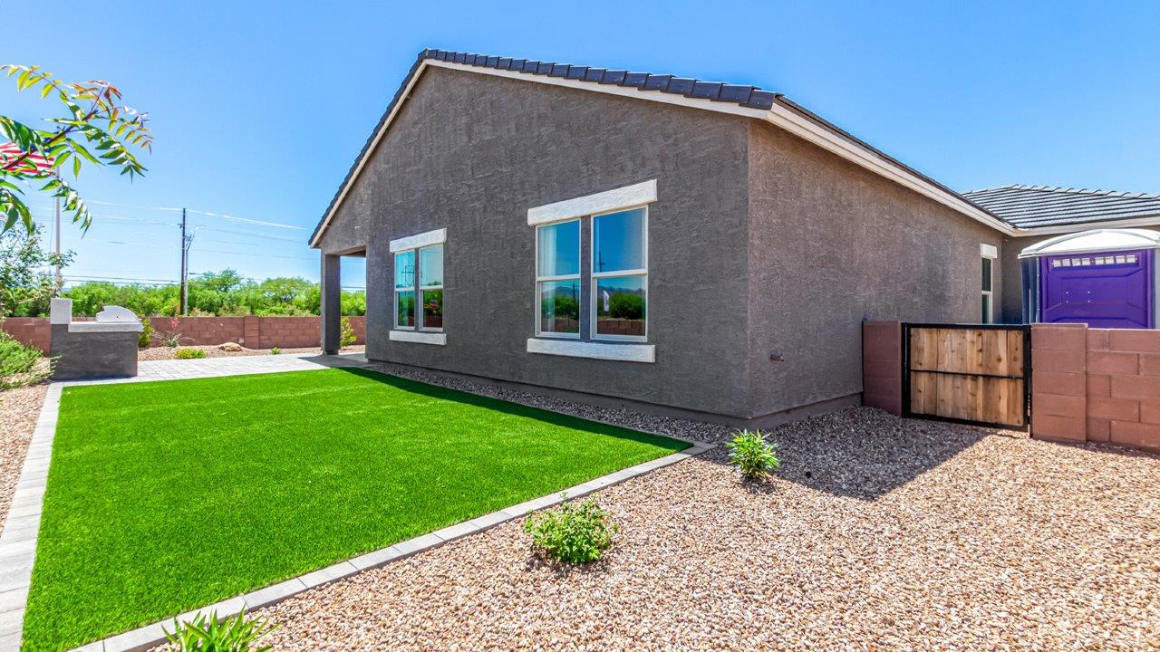 Introducing The Cali, a charming single-story new home located in the expansive Sahuarita Acres community. Covering 1,823 square feet, this home offers four bedrooms and two bathrooms, making it an excellent choice for families seeking both space and modern comfort.  As you step through the front porch and into the welcoming entryway, you’re immediately led into the heart of the home. The open-concept great room seamlessly connects to the dining area and kitchen, creating a perfect space for gathering with family and friends. The kitchen is a standout feature, boasting a central island, sleek granite countertops, and stylish 42” upper cabinets that offer ample storage. A spacious pantry adds to the kitchen’s functionality, ensuring everything you need is within reach.  The Cali’s layout is thoughtfully designed to maximize privacy and comfort. The primary bedroom, located at the rear of the home, features a large walk-in closet and an en-suite bathroom with dual sinks, providing a private space to start and end your day. The additional three bedrooms are situated toward the front of the home, each offering plenty of closet space and easy access to a full bathroom, making this layout ideal for families or guests.  One of the highlights of The Cali is the outdoor living space. The covered patio extends from the great room, offering an ideal spot to enjoy the expansive near one-acre lots that Sahuarita Acres is known for. Whether you’re planning to create a dream outdoor oasis or simply enjoy the natural surroundings, this space offers endless possibilities.  Built with modern living in mind, The Cali includes D.R. Horton’s Home is Connected® Smart Home package, featuring a smart thermostat, video doorbell, keyless entry, and a Wi-Fi-enabled garage door opener. Energy efficiency is also a priority, with spray foam insulation and designs that meet the DOE Zero Energy Ready Home standards, ensuring long-term savings and environmental benefits.  Located within the serene Sahuarita Acres community, residents of The Cali enjoy the luxury of space combined with easy access to urban amenities. With a three-car garage and RV parking on a 30’ driveway, this home is designed to accommodate your lifestyle while offering a peaceful retreat from the hustle and bustle.  Come home to The Cali, where comfort, style, and the beauty of Arizona living come together in perfect harmony.
