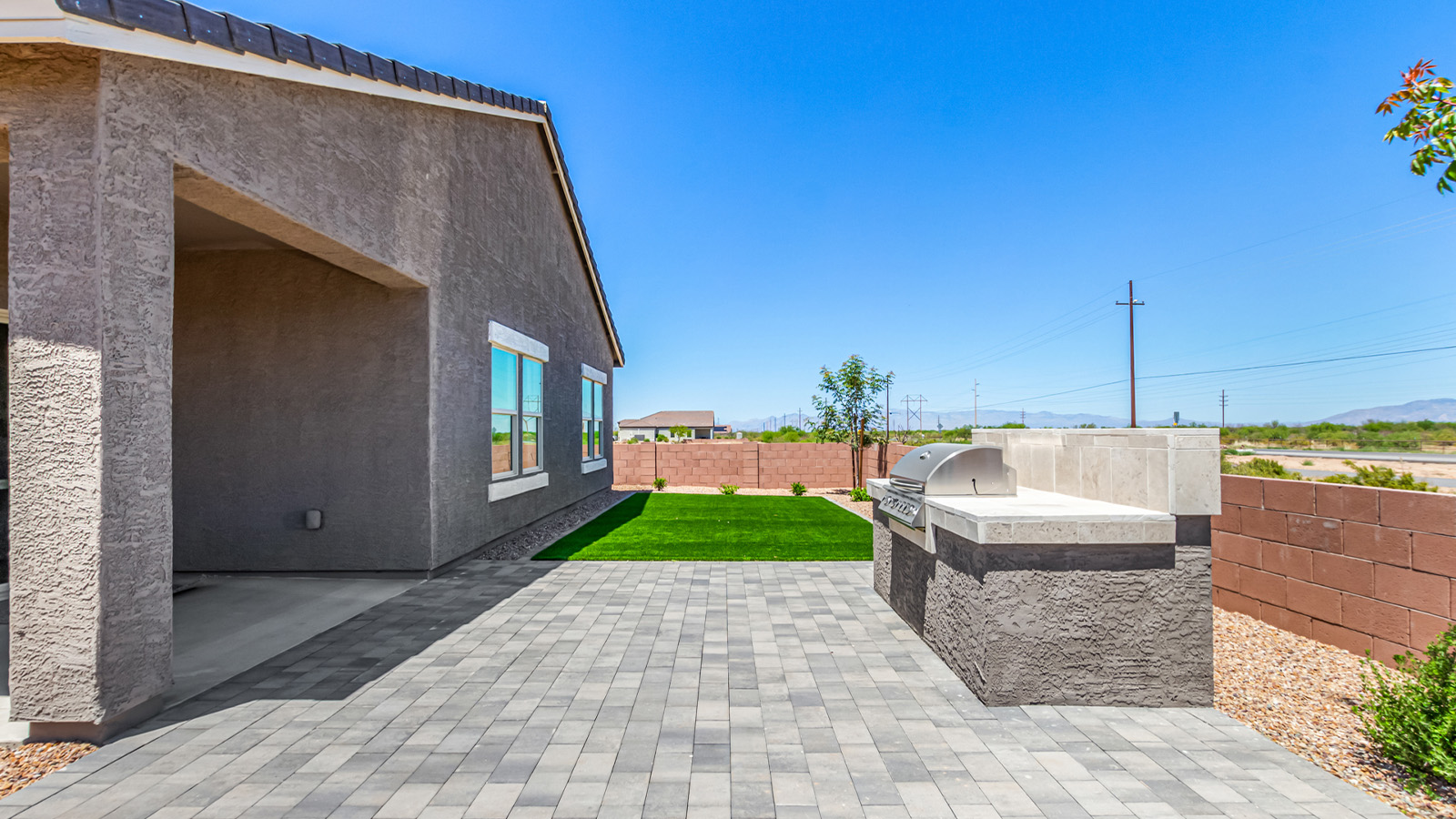 Introducing The Cali, a charming single-story new home located in the expansive Sahuarita Acres community. Covering 1,823 square feet, this home offers four bedrooms and two bathrooms, making it an excellent choice for families seeking both space and modern comfort.  As you step through the front porch and into the welcoming entryway, you’re immediately led into the heart of the home. The open-concept great room seamlessly connects to the dining area and kitchen, creating a perfect space for gathering with family and friends. The kitchen is a standout feature, boasting a central island, sleek granite countertops, and stylish 42” upper cabinets that offer ample storage. A spacious pantry adds to the kitchen’s functionality, ensuring everything you need is within reach.  The Cali’s layout is thoughtfully designed to maximize privacy and comfort. The primary bedroom, located at the rear of the home, features a large walk-in closet and an en-suite bathroom with dual sinks, providing a private space to start and end your day. The additional three bedrooms are situated toward the front of the home, each offering plenty of closet space and easy access to a full bathroom, making this layout ideal for families or guests.  One of the highlights of The Cali is the outdoor living space. The covered patio extends from the great room, offering an ideal spot to enjoy the expansive near one-acre lots that Sahuarita Acres is known for. Whether you’re planning to create a dream outdoor oasis or simply enjoy the natural surroundings, this space offers endless possibilities.  Built with modern living in mind, The Cali includes D.R. Horton’s Home is Connected® Smart Home package, featuring a smart thermostat, video doorbell, keyless entry, and a Wi-Fi-enabled garage door opener. Energy efficiency is also a priority, with spray foam insulation and designs that meet the DOE Zero Energy Ready Home standards, ensuring long-term savings and environmental benefits.  Located within the serene Sahuarita Acres community, residents of The Cali enjoy the luxury of space combined with easy access to urban amenities. With a three-car garage and RV parking on a 30’ driveway, this home is designed to accommodate your lifestyle while offering a peaceful retreat from the hustle and bustle.  Come home to The Cali, where comfort, style, and the beauty of Arizona living come together in perfect harmony.