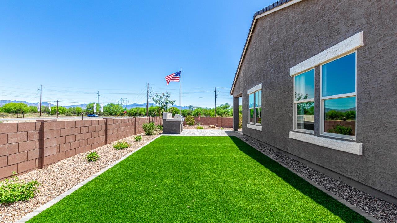 Introducing The Cali, a charming single-story new home located in the expansive Sahuarita Acres community. Covering 1,823 square feet, this home offers four bedrooms and two bathrooms, making it an excellent choice for families seeking both space and modern comfort.  As you step through the front porch and into the welcoming entryway, you’re immediately led into the heart of the home. The open-concept great room seamlessly connects to the dining area and kitchen, creating a perfect space for gathering with family and friends. The kitchen is a standout feature, boasting a central island, sleek granite countertops, and stylish 42” upper cabinets that offer ample storage. A spacious pantry adds to the kitchen’s functionality, ensuring everything you need is within reach.  The Cali’s layout is thoughtfully designed to maximize privacy and comfort. The primary bedroom, located at the rear of the home, features a large walk-in closet and an en-suite bathroom with dual sinks, providing a private space to start and end your day. The additional three bedrooms are situated toward the front of the home, each offering plenty of closet space and easy access to a full bathroom, making this layout ideal for families or guests.  One of the highlights of The Cali is the outdoor living space. The covered patio extends from the great room, offering an ideal spot to enjoy the expansive near one-acre lots that Sahuarita Acres is known for. Whether you’re planning to create a dream outdoor oasis or simply enjoy the natural surroundings, this space offers endless possibilities.  Built with modern living in mind, The Cali includes D.R. Horton’s Home is Connected® Smart Home package, featuring a smart thermostat, video doorbell, keyless entry, and a Wi-Fi-enabled garage door opener. Energy efficiency is also a priority, with spray foam insulation and designs that meet the DOE Zero Energy Ready Home standards, ensuring long-term savings and environmental benefits.  Located within the serene Sahuarita Acres community, residents of The Cali enjoy the luxury of space combined with easy access to urban amenities. With a three-car garage and RV parking on a 30’ driveway, this home is designed to accommodate your lifestyle while offering a peaceful retreat from the hustle and bustle.  Come home to The Cali, where comfort, style, and the beauty of Arizona living come together in perfect harmony.