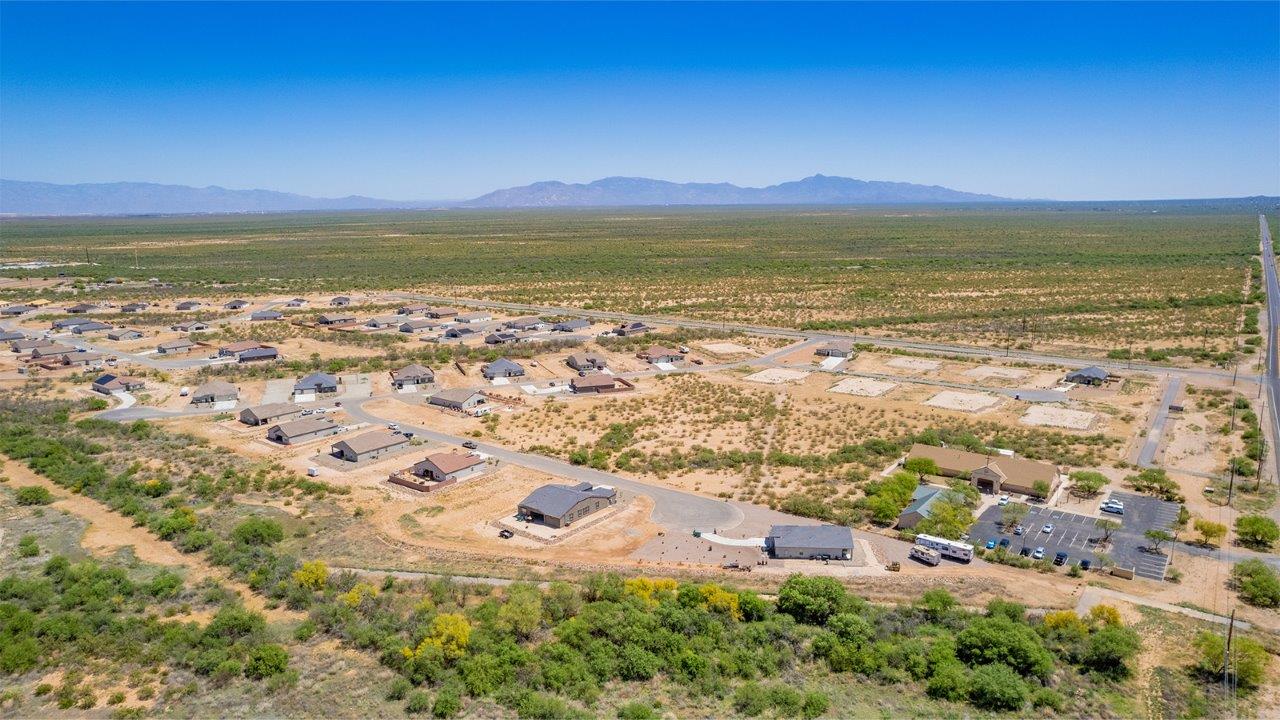 Introducing The Cali, a charming single-story new home located in the expansive Sahuarita Acres community. Covering 1,823 square feet, this home offers four bedrooms and two bathrooms, making it an excellent choice for families seeking both space and modern comfort.  As you step through the front porch and into the welcoming entryway, you’re immediately led into the heart of the home. The open-concept great room seamlessly connects to the dining area and kitchen, creating a perfect space for gathering with family and friends. The kitchen is a standout feature, boasting a central island, sleek granite countertops, and stylish 42” upper cabinets that offer ample storage. A spacious pantry adds to the kitchen’s functionality, ensuring everything you need is within reach.  The Cali’s layout is thoughtfully designed to maximize privacy and comfort. The primary bedroom, located at the rear of the home, features a large walk-in closet and an en-suite bathroom with dual sinks, providing a private space to start and end your day. The additional three bedrooms are situated toward the front of the home, each offering plenty of closet space and easy access to a full bathroom, making this layout ideal for families or guests.  One of the highlights of The Cali is the outdoor living space. The covered patio extends from the great room, offering an ideal spot to enjoy the expansive near one-acre lots that Sahuarita Acres is known for. Whether you’re planning to create a dream outdoor oasis or simply enjoy the natural surroundings, this space offers endless possibilities.  Built with modern living in mind, The Cali includes D.R. Horton’s Home is Connected® Smart Home package, featuring a smart thermostat, video doorbell, keyless entry, and a Wi-Fi-enabled garage door opener. Energy efficiency is also a priority, with spray foam insulation and designs that meet the DOE Zero Energy Ready Home standards, ensuring long-term savings and environmental benefits.  Located within the serene Sahuarita Acres community, residents of The Cali enjoy the luxury of space combined with easy access to urban amenities. With a three-car garage and RV parking on a 30’ driveway, this home is designed to accommodate your lifestyle while offering a peaceful retreat from the hustle and bustle.  Come home to The Cali, where comfort, style, and the beauty of Arizona living come together in perfect harmony.