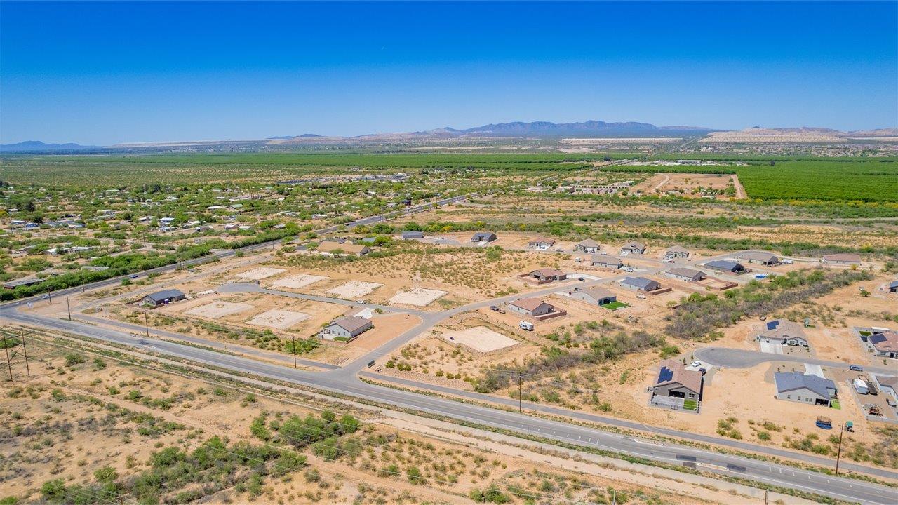 Introducing The Cali, a charming single-story new home located in the expansive Sahuarita Acres community. Covering 1,823 square feet, this home offers four bedrooms and two bathrooms, making it an excellent choice for families seeking both space and modern comfort.  As you step through the front porch and into the welcoming entryway, you’re immediately led into the heart of the home. The open-concept great room seamlessly connects to the dining area and kitchen, creating a perfect space for gathering with family and friends. The kitchen is a standout feature, boasting a central island, sleek granite countertops, and stylish 42” upper cabinets that offer ample storage. A spacious pantry adds to the kitchen’s functionality, ensuring everything you need is within reach.  The Cali’s layout is thoughtfully designed to maximize privacy and comfort. The primary bedroom, located at the rear of the home, features a large walk-in closet and an en-suite bathroom with dual sinks, providing a private space to start and end your day. The additional three bedrooms are situated toward the front of the home, each offering plenty of closet space and easy access to a full bathroom, making this layout ideal for families or guests.  One of the highlights of The Cali is the outdoor living space. The covered patio extends from the great room, offering an ideal spot to enjoy the expansive near one-acre lots that Sahuarita Acres is known for. Whether you’re planning to create a dream outdoor oasis or simply enjoy the natural surroundings, this space offers endless possibilities.  Built with modern living in mind, The Cali includes D.R. Horton’s Home is Connected® Smart Home package, featuring a smart thermostat, video doorbell, keyless entry, and a Wi-Fi-enabled garage door opener. Energy efficiency is also a priority, with spray foam insulation and designs that meet the DOE Zero Energy Ready Home standards, ensuring long-term savings and environmental benefits.  Located within the serene Sahuarita Acres community, residents of The Cali enjoy the luxury of space combined with easy access to urban amenities. With a three-car garage and RV parking on a 30’ driveway, this home is designed to accommodate your lifestyle while offering a peaceful retreat from the hustle and bustle.  Come home to The Cali, where comfort, style, and the beauty of Arizona living come together in perfect harmony.