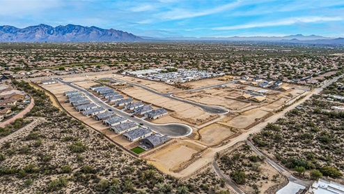 Welcome to Tortolita Trails, where new homes by D.R. Horton blend luxury and nature in the prestigious Dove Mountain area of Marana, Arizona. This exclusive community offers a serene living experience with only 82 homesites spread across 30 spacious acres, ensuring a low-density environment that provides ample privacy and tranquility. Surrounded by breathtaking 360-degree views of the Tortolita and Catalina Mountains, Tortolita Trails is a nature lover’s dream, with easy access to numerous trailheads, parks, and outdoor activities. Tortolita Trails features six charming single-story floor plans, ranging from 1,400 to 1,900 square feet, each crafted with high-quality finishes and modern amenities. Homes in this community feature spacious lots, beautiful Spanish lace stucco exteriors, tile roofs, and exquisitely landscaped front yards with auto drip irrigation. Inside, you’ll find luxurious quartz countertops in the kitchens and bathrooms, tile shower walls, 42” shaker-style cabinets, and stunning wood-look tile flooring throughout the main living areas. Each home is designed for comfort and convenience, with 9-foot ceilings, recessed lighting, and a Home is Connected® Smart Home package that includes a smart thermostat, video doorbell, keyless entry, a Wi-Fi-enabled garage door opener and more. These homes are not only stylish but also energy-efficient, meeting the stringent DOE Zero Energy Ready Home standards. Equipped with tankless water heaters, energy-efficient LED lighting, and advanced spray foam insulation, these homes are designed to reduce your environmental footprint while providing long-term savings on energy costs. Additionally, each home includes a single basin stainless steel kitchen sink with a water filtration system and a soft water loop for enhanced water quality. Living in Tortolita Trails means being part of a community that values both elegance and connection to nature. The community offers a range of amenities, including a park, playground, walking paths, ramadas, and grassy areas with picnic benches, perfect for family gatherings and outdoor activities. The prestigious Golf Club at Dove Mountain and the 5-star Ritz Carlton Resort are just minutes away, offering world-class golfing, dining, and spa experiences. Families will appreciate the top-rated Marana Unified School District, with the highly-rated Dove Mountain CSTEM K-8 School within walking distance. The community’s location also provides easy access to shopping, dining, and entertainment, with the nearby Houghton Town Center and Tangerine Sky Community Park offering everything you need just a short drive away. For outdoor enthusiasts, Tortolita Trails is surrounded by natural beauty and endless recreational opportunities. Explore the 29 miles of trails at Tortolita Mountain Park, or visit the nearby Tortolita Preserve, a 2,400-acre expanse of untouched desert perfect for hiking, biking, and wildlife viewing. The community’s proximity to Saguaro National Park and the Camino Loma Alta Bike Trail further enhances its appeal to those who love the outdoors. Come home to Tortolita Trails, where the fusion of elegant living and natural splendor creates an unparalleled lifestyle. Embrace the essence of Arizona living at its finest in this extraordinary community.