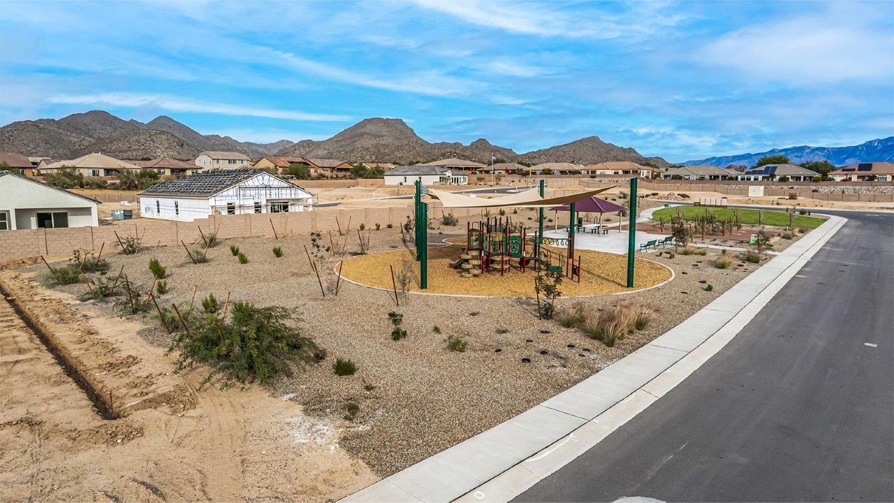 Introducing The Citrine, the crown jewel and largest floorplan within the Tortolita Trails community, located in the scenic Dove Mountain area of Marana, Arizona. Spanning 2,577 square feet, this impressive single-story new home offers a blend of space, style, and contemporary convenience, perfect for families seeking room to grow and entertain.  As you step through the welcoming entryway, you’re immediately drawn into the expansive great room, which flows comfortably into the dining area and kitchen. This open layout creates a warm and inviting atmosphere, ideal for both casual family dinners and larger gatherings. The kitchen is a chef's delight, complete with a spacious island, high-end quartz countertops, and ample storage within the 42” shaker-style cabinets. Adjacent to the kitchen, a cozy nook provides the perfect spot for morning coffee while enjoying views of the backyard.  The Citrine boasts five well-appointed bedrooms, providing flexibility for various lifestyle needs. The primary bedroom is situated at the rear of the home for added privacy, featuring a generous walk-in closet and a luxurious en-suite bathroom with dual sinks and a tiled shower. The additional four bedrooms are thoughtfully distributed throughout the home, offering comfort and convenience for guests or family members.  Outdoor living is a key feature of The Citrine, with a covered patio that extends the living space into the backyard, perfect for al fresco dining or simply relaxing in the shade. The two-car garage not only provides ample space for vehicles but also includes additional storage options to keep your home organized.  Energy efficiency and modern technology are at the forefront of The Citrine’s design. The home is equipped with tankless water heaters, energy-efficient LED lighting, and advanced spray foam insulation, all meeting the stringent DOE Zero Energy Ready Home standards. A Home is Connected® Smart Home package further enhances everyday living, with features like a smart thermostat, video doorbell, keyless entry, a Wi-Fi-enabled garage door opener and more.   As the largest floorplan within Tortolita Trails, The Citrine stands out not only for its size but also for its intentional layout and premium finishes. This home offers an unparalleled living experience in a community that embraces both elegance and a deep connection to nature. With easy access to outdoor activities, top-rated schools, and upscale amenities, The Citrine provides the perfect blend of comfort, style, and convenience in one of Arizona's most desirable neighborhoods.