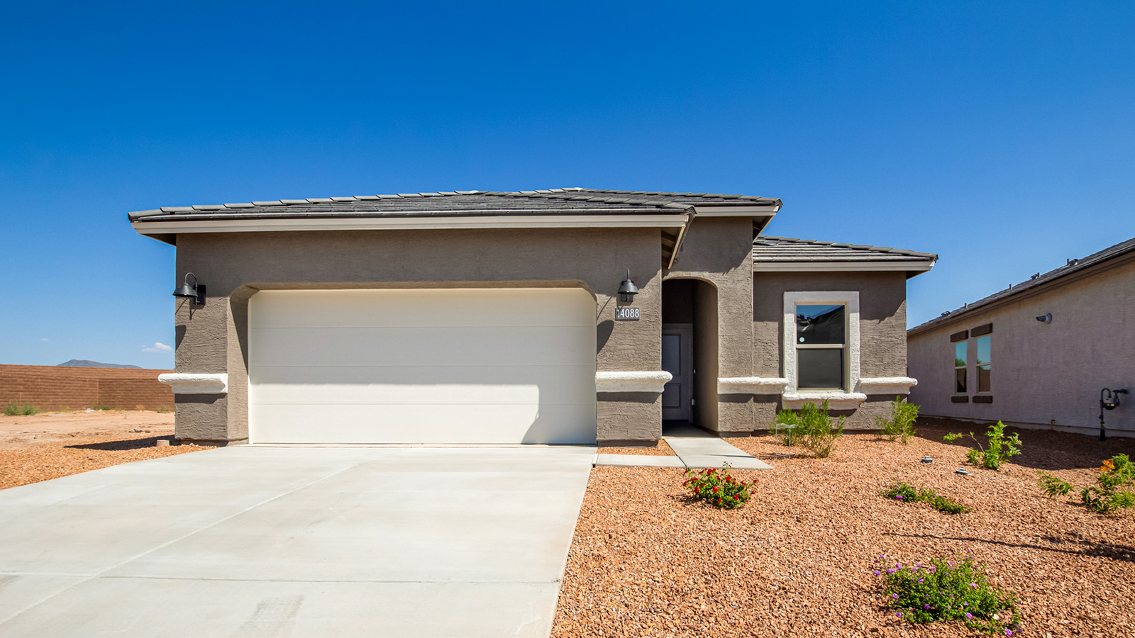 Welcome to Tortolita Trails, where luxury meets nature in the serene surroundings of Dove Mountain, Marana, Arizona. The Baxter is a well-conceived new home within this exclusive community, offering 1,423 square feet of pure comfort and convenience. This three-bedroom, two-bathroom home is designed to fit the needs of modern living while blending seamlessly with the natural beauty of its surroundings.  Upon entering The Baxter, you'll be greeted by a spacious great room that flows effortlessly into the dining area and kitchen, making it an ideal space for gatherings. The kitchen, with its large pantry, modern appliances, and ample counter space, is the heart of this home, ready to handle everything from weeknight dinners to holiday feasts. The adjacent dining area opens to a covered patio, perfect for enjoying the beautiful Arizona evenings.  The primary bedroom is a true haven, featuring a walk-in closet and an en-suite bathroom that offers both privacy and functionality. The additional two bedrooms are well-sized, providing flexibility for family, guests, or a home office. With a three-car garage, you'll have plenty of space for vehicles, storage, or even a workshop.  The Baxter also includes a range of standard features that enhance everyday living. Enjoy energy-efficient construction that not only reduces your carbon footprint but also lowers utility bills. The home is equipped with advanced insulation, energy-efficient windows, and smart home technology, ensuring comfort and convenience year-round.  Living in Tortolita Trails means you’re part of a community that values both luxury and sustainability. With access to extensive walking trails, parks, and outdoor activities, as well as proximity to top-rated schools and essential amenities, The Baxter offers a lifestyle that’s hard to match.  Come home to The Baxter at Tortolita Trails, where every detail is designed to enhance your everyday life while allowing you to enjoy the natural beauty of Arizona to the fullest.