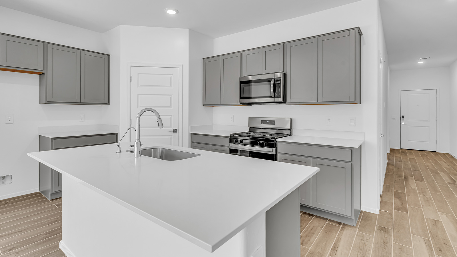 Discover the essence of Arizona living at Tortolita Trails, where The Cali plan offers an inviting blend of comfort and style. This 1,823 square foot single-story new home, located in the prestigious Dove Mountain area of Marana, Arizona, is designed to accommodate the needs of modern families. With four bedrooms and two bathrooms, The Cali provides ample space for relaxation, entertaining, and everything in between.  Step inside and be greeted by an open-concept layout that seamlessly connects the kitchen, dining room, and great room, creating a spacious environment perfect for gatherings. The kitchen, featuring a large pantry, modern appliances, and ample counter space, is a home chef's dream. The adjoining great room, with easy access to a covered patio, invites you to extend your living space outdoors, perfect for enjoying Arizona’s year-round sunshine.  The private primary suite is a true highlight, offering a spacious bedroom, a walk-in closet, and a bathroom complete with dual sinks and a large shower. Three additional bedrooms provide versatility for family members, guests, or a home office setup. A second bathroom, conveniently located near these bedrooms, ensures comfort for all.  In The Cali, you'll find a range of high-quality standard features that elevate your living experience. The home includes a modern kitchen with a large pantry, quartz countertops, stylish cabinetry, and energy-efficient appliances. The great room, designed for both comfort and functionality, connects seamlessly to the dining area and kitchen, creating an ideal space for entertaining. The covered patio offers an inviting outdoor retreat, perfect for enjoying Arizona's beautiful weather. Additionally, the home includes a two-car garage, providing ample storage and parking space.  Practicality meets style in The Cali, with thoughtful design elements like a utility room, abundant storage, and a two-car garage. Energy-efficient features throughout the home ensure that you can enjoy your space comfortably while keeping utility costs low.  Outside, Tortolita Trails offers a community atmosphere enriched with scenic views, recreational trails, and proximity to top-rated schools, shopping, and dining options. Whether you’re relaxing on the covered patio or exploring the surrounding natural beauty, The Cali at Tortolita Trails provides the perfect balance of modern living and outdoor adventure.