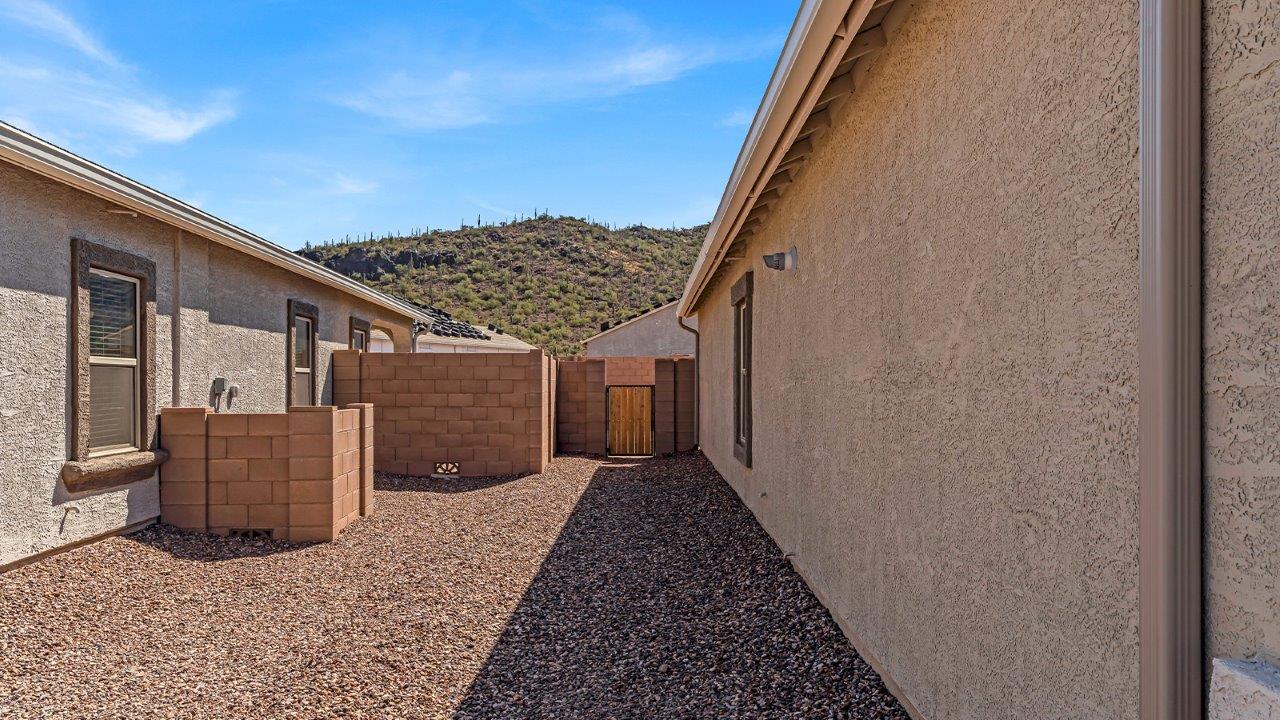 Discover the essence of Arizona living at Tortolita Trails, where The Cali plan offers an inviting blend of comfort and style. This 1,823 square foot single-story new home, located in the prestigious Dove Mountain area of Marana, Arizona, is designed to accommodate the needs of modern families. With four bedrooms and two bathrooms, The Cali provides ample space for relaxation, entertaining, and everything in between.  Step inside and be greeted by an open-concept layout that seamlessly connects the kitchen, dining room, and great room, creating a spacious environment perfect for gatherings. The kitchen, featuring a large pantry, modern appliances, and ample counter space, is a home chef's dream. The adjoining great room, with easy access to a covered patio, invites you to extend your living space outdoors, perfect for enjoying Arizona’s year-round sunshine.  The private primary suite is a true highlight, offering a spacious bedroom, a walk-in closet, and a bathroom complete with dual sinks and a large shower. Three additional bedrooms provide versatility for family members, guests, or a home office setup. A second bathroom, conveniently located near these bedrooms, ensures comfort for all.  In The Cali, you'll find a range of high-quality standard features that elevate your living experience. The home includes a modern kitchen with a large pantry, quartz countertops, stylish cabinetry, and energy-efficient appliances. The great room, designed for both comfort and functionality, connects seamlessly to the dining area and kitchen, creating an ideal space for entertaining. The covered patio offers an inviting outdoor retreat, perfect for enjoying Arizona's beautiful weather. Additionally, the home includes a two-car garage, providing ample storage and parking space.  Practicality meets style in The Cali, with thoughtful design elements like a utility room, abundant storage, and a two-car garage. Energy-efficient features throughout the home ensure that you can enjoy your space comfortably while keeping utility costs low.  Outside, Tortolita Trails offers a community atmosphere enriched with scenic views, recreational trails, and proximity to top-rated schools, shopping, and dining options. Whether you’re relaxing on the covered patio or exploring the surrounding natural beauty, The Cali at Tortolita Trails provides the perfect balance of modern living and outdoor adventure.