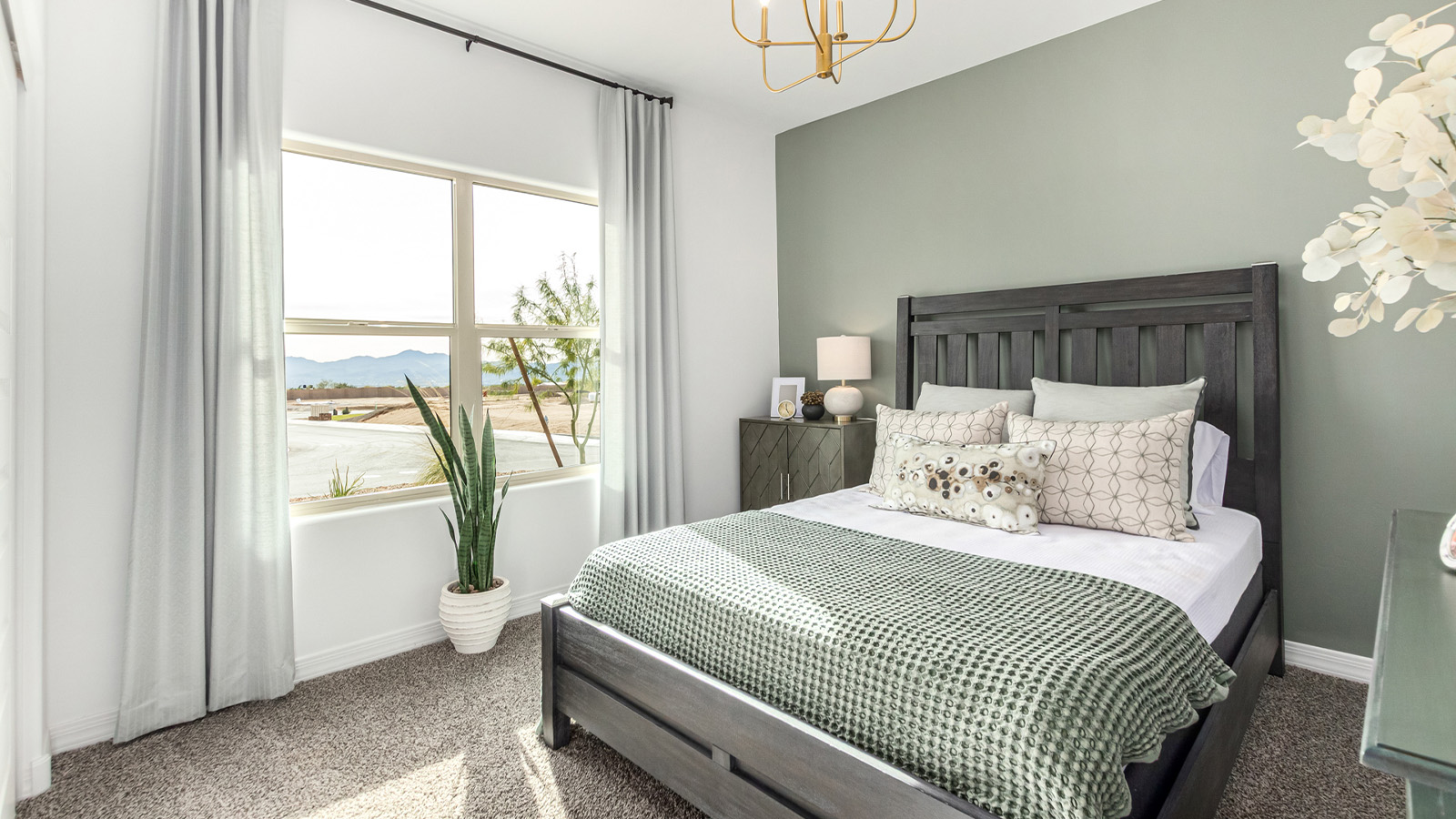 Introducing The Kingston, a spacious four-bedroom home settled within the peaceful community of Tortolita Trails in Marana, Arizona. With 2,051 square feet of living space, this single-story new home design offers both comfort and practicality for modern family life.