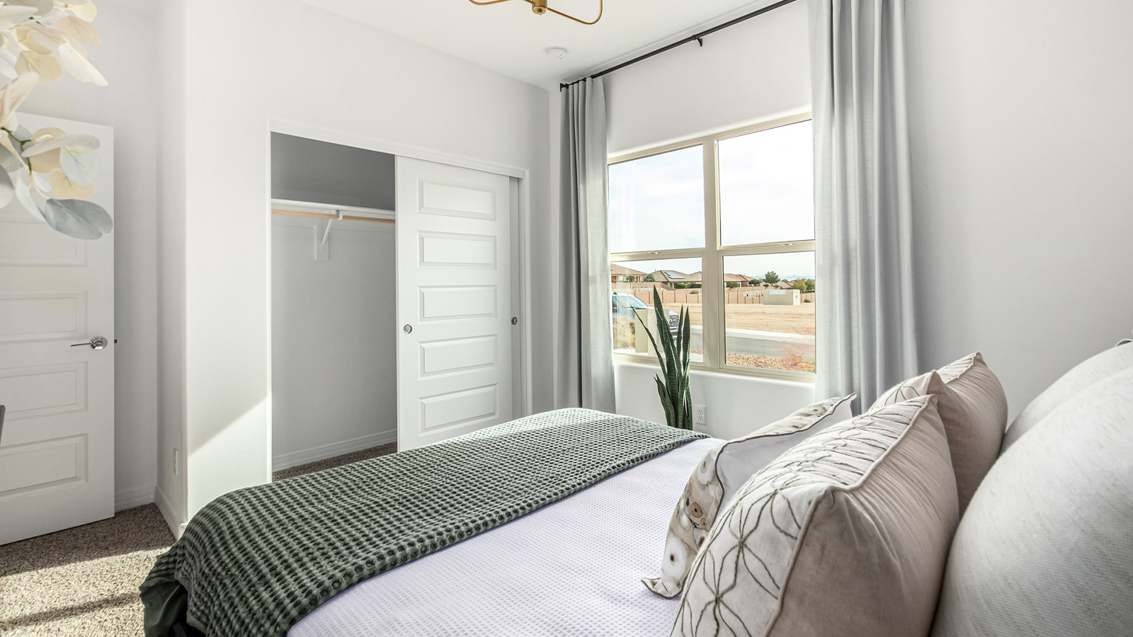 Introducing The Kingston, a spacious four-bedroom home settled within the peaceful community of Tortolita Trails in Marana, Arizona. With 2,051 square feet of living space, this single-story new home design offers both comfort and practicality for modern family life.  Upon entering, you're greeted by a welcoming foyer that flows into an open-concept layout, where each area of the home is thoughtfully arranged for easy living. The kitchen, complete with a large quartz countertop island and top-of-the-line appliances, is perfectly suited for both everyday meals and special gatherings. Adjacent to the kitchen, the great room invites relaxation and socializing, with direct access to a covered patio where you can unwind and appreciate the desert views.  The primary suite is a private retreat, featuring a generous walk-in closet and an en-suite bathroom with dual sinks and a walk-in shower. The three additional bedrooms are well-sized, providing ample space for family, guests, or a home office. A second bathroom and a convenient utility room add to the home's functionality.  Homes at Tortolita Trails are equipped with high-quality features, including quartz countertops, 42” shaker-style cabinets, and durable wood-look tile flooring. The community’s focus on energy efficiency is reflected in the inclusion of tankless water heaters, LED lighting, and advanced spray foam insulation, offering both comfort and cost savings.  The Kingston also includes a suite of smart home features, such as a video doorbell, keyless entry, a Wi-Fi-enabled garage door opener and more, all designed to make your daily life easier and more connected.  Living in Tortolita Trails means enjoying the perfect balance of privacy and community, with access to parks, playgrounds, and miles of scenic trails. The Kingston at Tortolita Trails offers a blend of modern conveniences and natural surroundings, making it the ideal place to call home.