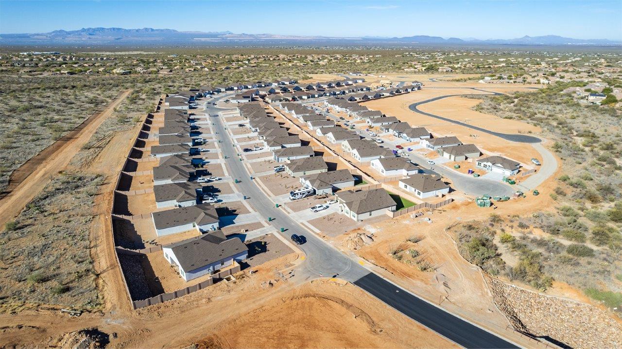 Snuggled within the serene surroundings of Sycamore Vista, The Baxter offers a blend of comfort and convenience, making it a perfect fit for modern living. Spanning 1,423 square feet, this thoughtfully crafted single-story home features three bedrooms, two bathrooms, and a flexible 2-3 car garage, all within the picturesque foothills of the Santa Rita Mountains.  As you step onto the welcoming front porch and enter through the foyer, you’re greeted by a spacious and open floor plan that flows effortlessly into the heart of the home. The great room is designed for both relaxation and socializing, seamlessly connecting to the dining area and kitchen. The kitchen is a culinary enthusiast's dream, featuring sleek granite countertops, a central island, and Shaker-style cabinetry, all designed to offer ample storage and a stylish backdrop for your cooking adventures. The adjacent pantry ensures that all your essentials are within easy reach, making meal prep both efficient and enjoyable.  The primary bedroom, located at the rear of the home for enhanced privacy, serves as a peaceful retreat. It includes a spacious walk-in closet and an en-suite bathroom equipped with dual vanities and a luxurious shower. The two additional bedrooms are thoughtfully positioned near the front of the home, sharing a full bathroom, making it ideal for families or guests.  Outdoor living is a key feature of The Baxter, with a covered patio that extends from the dining area, offering the perfect space to enjoy Tucson’s stunning sunsets or host a weekend barbecue. The 2-3 car garage provides ample space for vehicles, storage, or even a small workshop, catering to various needs.  Living in Sycamore Vista means you’re part of a community that values both convenience and quality of life. Each home in this community comes with beautifully landscaped front yards, equipped with auto drip irrigation systems and soft water loops, enhancing the beauty and functionality of your outdoor space. Additionally, Sycamore Vista homes are energy-efficient, featuring DOE Zero Energy Ready standards, including spray foam insulation, tankless water heaters, and LED lighting throughout, ensuring lower energy costs and a reduced environmental footprint.  The community’s higher elevation not only offers cooler summer temperatures but also less light pollution, making it a perfect spot for stargazing. Sycamore Vista is ideally located near top-rated schools in the Vail School District, including Sycamore Elementary and Corona Foothills Middle School, making it an ideal choice for families.  Beyond the tranquility of home, outdoor enthusiasts will appreciate the proximity to local state and national parks, including Coronado National Forest and Colossal Cave Mountain Park, offering endless opportunities for hiking, biking, and exploring Arizona’s natural beauty. The community’s location also provides easy access to shopping, dining, and major employers like the Target Distribution Center and the Amazon Fulfillment Center, ensuring that everything you need is within reach.  Experience the best of Arizona living at Sycamore Vista, where The Baxter offers the perfect blend of modern amenities, quality craftsmanship, and the natural beauty of the Santa Rita Mountains, creating a place you’ll be proud to call home.