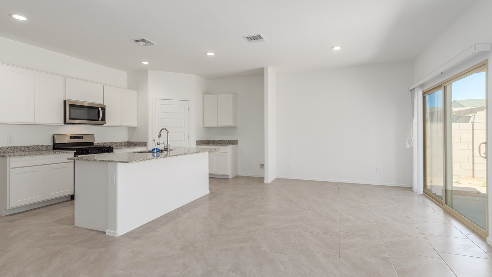 Experience the charm of The Cali, located within the peaceful Sycamore Vista community in the serene foothills of the Santa Rita Mountains, Arizona. This thoughtfully laid-out, single-story home offers 1,823 square feet of versatile living space designed to meet the needs of modern families.  Step into the inviting entryway, where you're welcomed by a spacious great room that serves as the heart of the home. The open-concept design connects the great room to the dining area and kitchen, creating a harmonious flow that's perfect for both entertaining and daily living. The kitchen is a true culinary haven, featuring a large island, granite countertops, and ample storage space with a walk-in pantry.  The Cali's four bedrooms are designed with relaxation in mind. The primary suite, tucked away from the other bedrooms, offers a private oasis complete with a walk-in closet and a well-appointed bathroom featuring dual vanities. The additional three bedrooms share a well-equipped bathroom and are situated to provide comfort and privacy for family members or guests.  Adding to the home's appeal are the premium standard features that come included in every Cali at Sycamore Vista. Enjoy the elegance of staggered wood-look ceramic tile flooring throughout the main living areas, complemented by Shaker-style cabinetry in the kitchen and bathrooms. The kitchen is further enhanced by an open single basin stainless steel sink paired with a water filtration system, making both cooking and cleanup a breeze. The energy-efficient design includes spray foam insulation, a tankless water heater, and LED lighting throughout, all contributing to lower utility costs and a more sustainable lifestyle.  Outdoor living is a breeze with the covered patio, easily accessible from the dining room, providing the perfect spot for morning coffee or evening gatherings. The three-car garage offers plenty of space for vehicles and storage, ensuring that everything you need is within easy reach.  Sycamore Vista's location offers a unique blend of tranquility and convenience, making The Cali an ideal choice for those seeking a peaceful retreat with easy access to modern amenities. Whether you're relaxing indoors or enjoying the outdoor beauty of Arizona, The Cali is a home that combines style, comfort, and functionality in every detail.