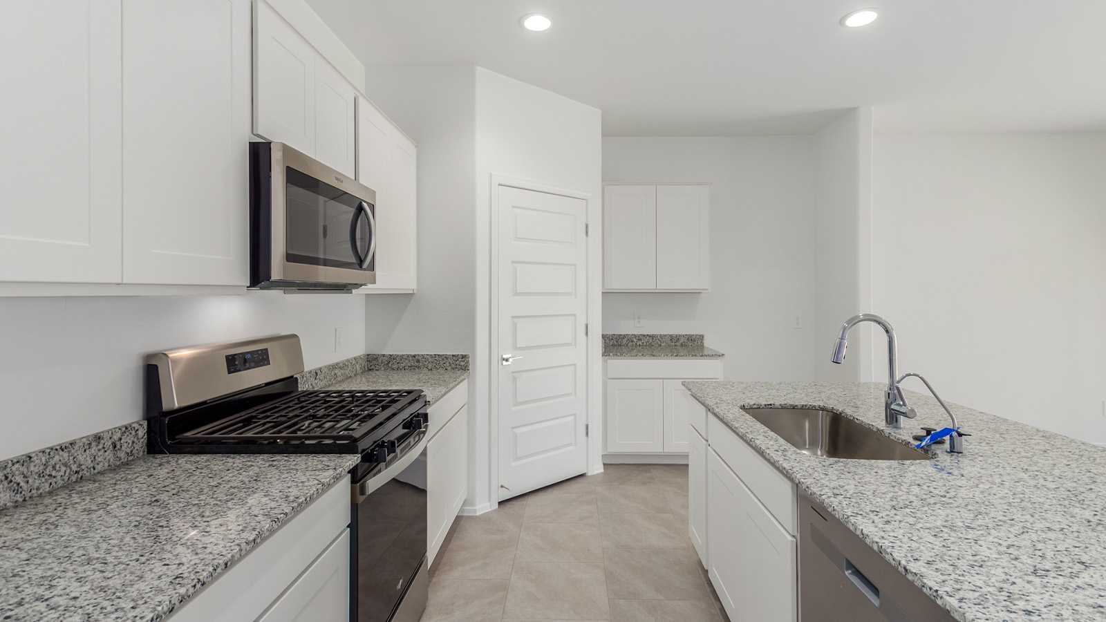 Experience the charm of The Cali, located within the peaceful Sycamore Vista community in the serene foothills of the Santa Rita Mountains, Arizona. This thoughtfully laid-out, single-story home offers 1,823 square feet of versatile living space designed to meet the needs of modern families.  Step into the inviting entryway, where you're welcomed by a spacious great room that serves as the heart of the home. The open-concept design connects the great room to the dining area and kitchen, creating a harmonious flow that's perfect for both entertaining and daily living. The kitchen is a true culinary haven, featuring a large island, granite countertops, and ample storage space with a walk-in pantry.  The Cali's four bedrooms are designed with relaxation in mind. The primary suite, tucked away from the other bedrooms, offers a private oasis complete with a walk-in closet and a well-appointed bathroom featuring dual vanities. The additional three bedrooms share a well-equipped bathroom and are situated to provide comfort and privacy for family members or guests.  Adding to the home's appeal are the premium standard features that come included in every Cali at Sycamore Vista. Enjoy the elegance of staggered wood-look ceramic tile flooring throughout the main living areas, complemented by Shaker-style cabinetry in the kitchen and bathrooms. The kitchen is further enhanced by an open single basin stainless steel sink paired with a water filtration system, making both cooking and cleanup a breeze. The energy-efficient design includes spray foam insulation, a tankless water heater, and LED lighting throughout, all contributing to lower utility costs and a more sustainable lifestyle.  Outdoor living is a breeze with the covered patio, easily accessible from the dining room, providing the perfect spot for morning coffee or evening gatherings. The three-car garage offers plenty of space for vehicles and storage, ensuring that everything you need is within easy reach.  Sycamore Vista's location offers a unique blend of tranquility and convenience, making The Cali an ideal choice for those seeking a peaceful retreat with easy access to modern amenities. Whether you're relaxing indoors or enjoying the outdoor beauty of Arizona, The Cali is a home that combines style, comfort, and functionality in every detail.