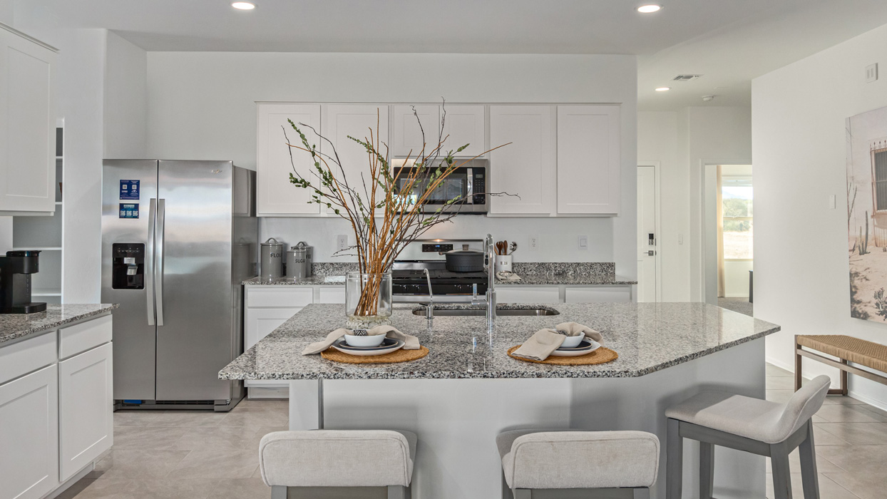 Welcome to the Kingston, a premier new home design situated in the picturesque Sycamore Vista community in Vail, Arizona. With an expansive 2,051 square feet of living space, this single-story home offers four bedrooms, two bathrooms, and a two-three car garage.  As you step inside, you are greeted by an inviting entryway that flows seamlessly into a heart of the home. The open-concept kitchen, equipped with a center island, modern appliances, and ample pantry space, makes it ideal for culinary adventures. Adjacent to the kitchen, the dining room offers easy access to the covered patio, where you can enjoy outdoor dining or simply relax in the tranquility of your private backyard.  The Kingston’s thoughtful layout ensures that every bedroom offers comfort and privacy. The primary suite, located at the rear of the home, features a large walk-in closet and an en-suite bathroom. The additional bedrooms are thoughtfully arranged to provide flexibility, whether you need a guest room, home office, or space for hobbies.  The Kingston is built with a focus on energy efficiency, featuring top-of-the-line insulation, energy-efficient appliances, and a smart home package that includes an automated thermostat, keyless entry, a Wi-Fi-enabled garage door opener, and more. This modern home not only offers comfort but also provides peace of mind with its energy-saving features and enhanced security systems.  Residents of Sycamore Vista enjoy a harmonious blend of rural tranquility and convenient urban access. With proximity to outdoor attractions like Coronado National Forest and Colossal Cave Mountain Park, as well as nearby schools and major employers, Sycamore Vista provides a unique living experience where nature and modern living coexist.  The Kingston at Sycamore Vista is more than just a house—it's a place to create lasting memories and live your best life.  *Images shown are for reference only. They depict the sales model home and may not represent the actual home.