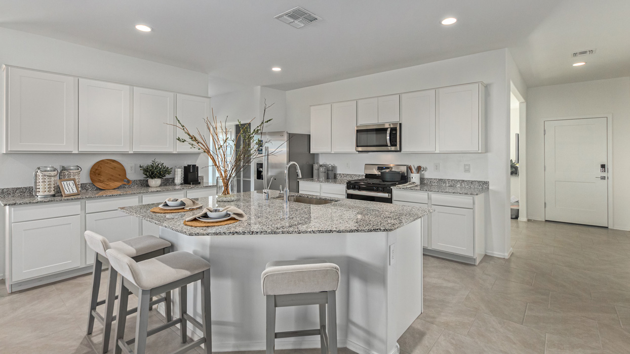 Welcome to the Kingston, a premier new home design situated in the picturesque Sycamore Vista community in Vail, Arizona. With an expansive 2,051 square feet of living space, this single-story home offers four bedrooms, two bathrooms, and a two-three car garage.  As you step inside, you are greeted by an inviting entryway that flows seamlessly into a heart of the home. The open-concept kitchen, equipped with a center island, modern appliances, and ample pantry space, makes it ideal for culinary adventures. Adjacent to the kitchen, the dining room offers easy access to the covered patio, where you can enjoy outdoor dining or simply relax in the tranquility of your private backyard.  The Kingston’s thoughtful layout ensures that every bedroom offers comfort and privacy. The primary suite, located at the rear of the home, features a large walk-in closet and an en-suite bathroom. The additional bedrooms are thoughtfully arranged to provide flexibility, whether you need a guest room, home office, or space for hobbies.  The Kingston is built with a focus on energy efficiency, featuring top-of-the-line insulation, energy-efficient appliances, and a smart home package that includes an automated thermostat, keyless entry, a Wi-Fi-enabled garage door opener, and more. This modern home not only offers comfort but also provides peace of mind with its energy-saving features and enhanced security systems.  Residents of Sycamore Vista enjoy a harmonious blend of rural tranquility and convenient urban access. With proximity to outdoor attractions like Coronado National Forest and Colossal Cave Mountain Park, as well as nearby schools and major employers, Sycamore Vista provides a unique living experience where nature and modern living coexist.  The Kingston at Sycamore Vista is more than just a house—it's a place to create lasting memories and live your best life.  *Images shown are for reference only. They depict the sales model home and may not represent the actual home.