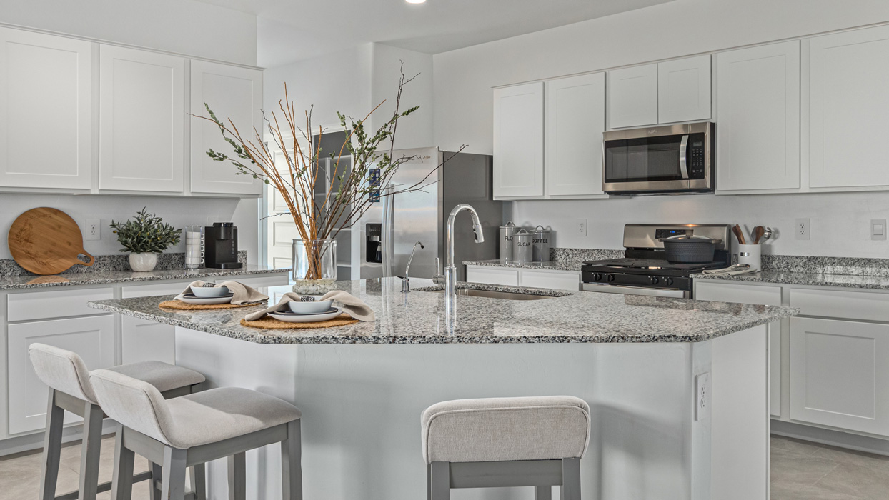 Welcome to the Kingston, a premier new home design situated in the picturesque Sycamore Vista community in Vail, Arizona. With an expansive 2,051 square feet of living space, this single-story home offers four bedrooms, two bathrooms, and a two-three car garage.  As you step inside, you are greeted by an inviting entryway that flows seamlessly into a heart of the home. The open-concept kitchen, equipped with a center island, modern appliances, and ample pantry space, makes it ideal for culinary adventures. Adjacent to the kitchen, the dining room offers easy access to the covered patio, where you can enjoy outdoor dining or simply relax in the tranquility of your private backyard.  The Kingston’s thoughtful layout ensures that every bedroom offers comfort and privacy. The primary suite, located at the rear of the home, features a large walk-in closet and an en-suite bathroom. The additional bedrooms are thoughtfully arranged to provide flexibility, whether you need a guest room, home office, or space for hobbies.  The Kingston is built with a focus on energy efficiency, featuring top-of-the-line insulation, energy-efficient appliances, and a smart home package that includes an automated thermostat, keyless entry, a Wi-Fi-enabled garage door opener, and more. This modern home not only offers comfort but also provides peace of mind with its energy-saving features and enhanced security systems.  Residents of Sycamore Vista enjoy a harmonious blend of rural tranquility and convenient urban access. With proximity to outdoor attractions like Coronado National Forest and Colossal Cave Mountain Park, as well as nearby schools and major employers, Sycamore Vista provides a unique living experience where nature and modern living coexist.  The Kingston at Sycamore Vista is more than just a house—it's a place to create lasting memories and live your best life.  *Images shown are for reference only. They depict the sales model home and may not represent the actual home.