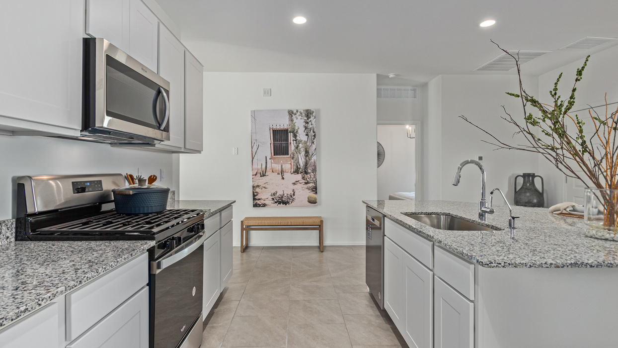 Welcome to the Kingston, a premier new home design situated in the picturesque Sycamore Vista community in Vail, Arizona. With an expansive 2,051 square feet of living space, this single-story home offers four bedrooms, two bathrooms, and a two-three car garage.  As you step inside, you are greeted by an inviting entryway that flows seamlessly into a heart of the home. The open-concept kitchen, equipped with a center island, modern appliances, and ample pantry space, makes it ideal for culinary adventures. Adjacent to the kitchen, the dining room offers easy access to the covered patio, where you can enjoy outdoor dining or simply relax in the tranquility of your private backyard.  The Kingston’s thoughtful layout ensures that every bedroom offers comfort and privacy. The primary suite, located at the rear of the home, features a large walk-in closet and an en-suite bathroom. The additional bedrooms are thoughtfully arranged to provide flexibility, whether you need a guest room, home office, or space for hobbies.  The Kingston is built with a focus on energy efficiency, featuring top-of-the-line insulation, energy-efficient appliances, and a smart home package that includes an automated thermostat, keyless entry, a Wi-Fi-enabled garage door opener, and more. This modern home not only offers comfort but also provides peace of mind with its energy-saving features and enhanced security systems.  Residents of Sycamore Vista enjoy a harmonious blend of rural tranquility and convenient urban access. With proximity to outdoor attractions like Coronado National Forest and Colossal Cave Mountain Park, as well as nearby schools and major employers, Sycamore Vista provides a unique living experience where nature and modern living coexist.  The Kingston at Sycamore Vista is more than just a house—it's a place to create lasting memories and live your best life.  *Images shown are for reference only. They depict the sales model home and may not represent the actual home.