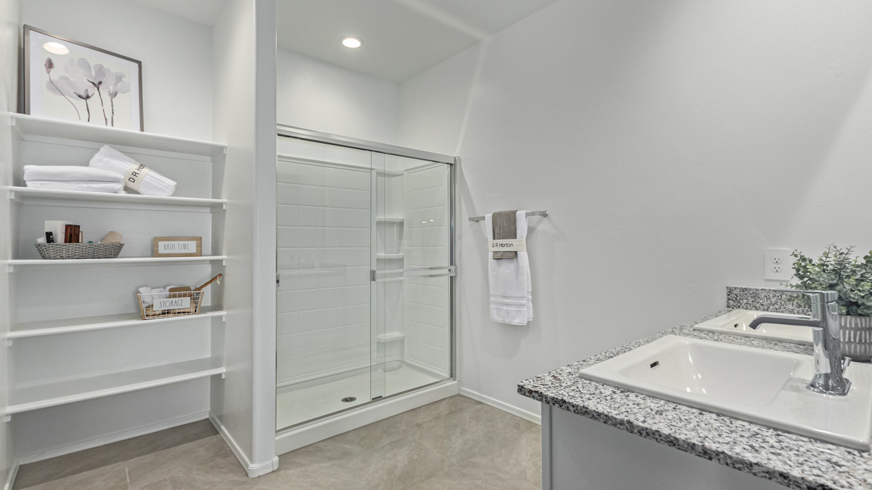 Welcome to the Kingston, a premier new home design situated in the picturesque Sycamore Vista community in Vail, Arizona. With an expansive 2,051 square feet of living space, this single-story home offers four bedrooms, two bathrooms, and a two-three car garage.  As you step inside, you are greeted by an inviting entryway that flows seamlessly into a heart of the home. The open-concept kitchen, equipped with a center island, modern appliances, and ample pantry space, makes it ideal for culinary adventures. Adjacent to the kitchen, the dining room offers easy access to the covered patio, where you can enjoy outdoor dining or simply relax in the tranquility of your private backyard.  The Kingston’s thoughtful layout ensures that every bedroom offers comfort and privacy. The primary suite, located at the rear of the home, features a large walk-in closet and an en-suite bathroom. The additional bedrooms are thoughtfully arranged to provide flexibility, whether you need a guest room, home office, or space for hobbies.  The Kingston is built with a focus on energy efficiency, featuring top-of-the-line insulation, energy-efficient appliances, and a smart home package that includes an automated thermostat, keyless entry, a Wi-Fi-enabled garage door opener, and more. This modern home not only offers comfort but also provides peace of mind with its energy-saving features and enhanced security systems.  Residents of Sycamore Vista enjoy a harmonious blend of rural tranquility and convenient urban access. With proximity to outdoor attractions like Coronado National Forest and Colossal Cave Mountain Park, as well as nearby schools and major employers, Sycamore Vista provides a unique living experience where nature and modern living coexist.  The Kingston at Sycamore Vista is more than just a house—it's a place to create lasting memories and live your best life.  *Images shown are for reference only. They depict the sales model home and may not represent the actual home.