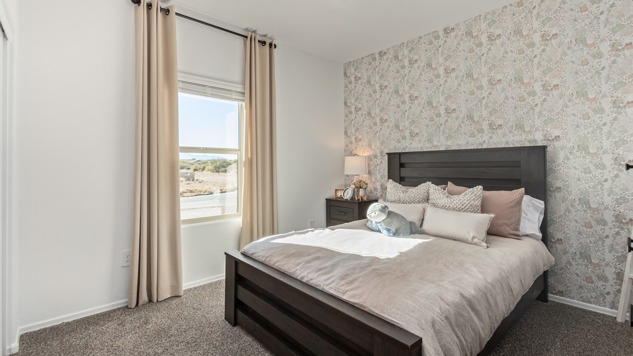 Welcome to the Kingston, a premier new home design situated in the picturesque Sycamore Vista community in Vail, Arizona. With an expansive 2,051 square feet of living space, this single-story home offers four bedrooms, two bathrooms, and a two-three car garage.  As you step inside, you are greeted by an inviting entryway that flows seamlessly into a heart of the home. The open-concept kitchen, equipped with a center island, modern appliances, and ample pantry space, makes it ideal for culinary adventures. Adjacent to the kitchen, the dining room offers easy access to the covered patio, where you can enjoy outdoor dining or simply relax in the tranquility of your private backyard.  The Kingston’s thoughtful layout ensures that every bedroom offers comfort and privacy. The primary suite, located at the rear of the home, features a large walk-in closet and an en-suite bathroom. The additional bedrooms are thoughtfully arranged to provide flexibility, whether you need a guest room, home office, or space for hobbies.  The Kingston is built with a focus on energy efficiency, featuring top-of-the-line insulation, energy-efficient appliances, and a smart home package that includes an automated thermostat, keyless entry, a Wi-Fi-enabled garage door opener, and more. This modern home not only offers comfort but also provides peace of mind with its energy-saving features and enhanced security systems.  Residents of Sycamore Vista enjoy a harmonious blend of rural tranquility and convenient urban access. With proximity to outdoor attractions like Coronado National Forest and Colossal Cave Mountain Park, as well as nearby schools and major employers, Sycamore Vista provides a unique living experience where nature and modern living coexist.  The Kingston at Sycamore Vista is more than just a house—it's a place to create lasting memories and live your best life.  *Images shown are for reference only. They depict the sales model home and may not represent the actual home.