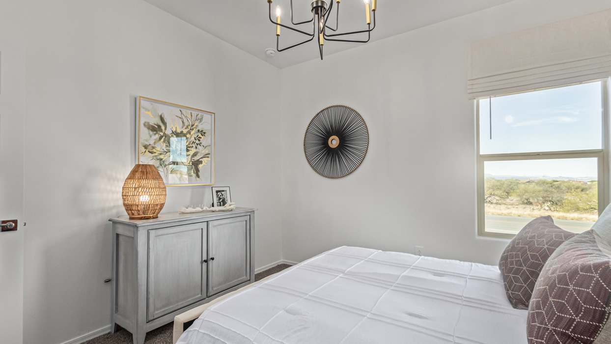 Welcome to the Kingston, a premier new home design situated in the picturesque Sycamore Vista community in Vail, Arizona. With an expansive 2,051 square feet of living space, this single-story home offers four bedrooms, two bathrooms, and a two-three car garage.  As you step inside, you are greeted by an inviting entryway that flows seamlessly into a heart of the home. The open-concept kitchen, equipped with a center island, modern appliances, and ample pantry space, makes it ideal for culinary adventures. Adjacent to the kitchen, the dining room offers easy access to the covered patio, where you can enjoy outdoor dining or simply relax in the tranquility of your private backyard.  The Kingston’s thoughtful layout ensures that every bedroom offers comfort and privacy. The primary suite, located at the rear of the home, features a large walk-in closet and an en-suite bathroom. The additional bedrooms are thoughtfully arranged to provide flexibility, whether you need a guest room, home office, or space for hobbies.  The Kingston is built with a focus on energy efficiency, featuring top-of-the-line insulation, energy-efficient appliances, and a smart home package that includes an automated thermostat, keyless entry, a Wi-Fi-enabled garage door opener, and more. This modern home not only offers comfort but also provides peace of mind with its energy-saving features and enhanced security systems.  Residents of Sycamore Vista enjoy a harmonious blend of rural tranquility and convenient urban access. With proximity to outdoor attractions like Coronado National Forest and Colossal Cave Mountain Park, as well as nearby schools and major employers, Sycamore Vista provides a unique living experience where nature and modern living coexist.  The Kingston at Sycamore Vista is more than just a house—it's a place to create lasting memories and live your best life.  *Images shown are for reference only. They depict the sales model home and may not represent the actual home.