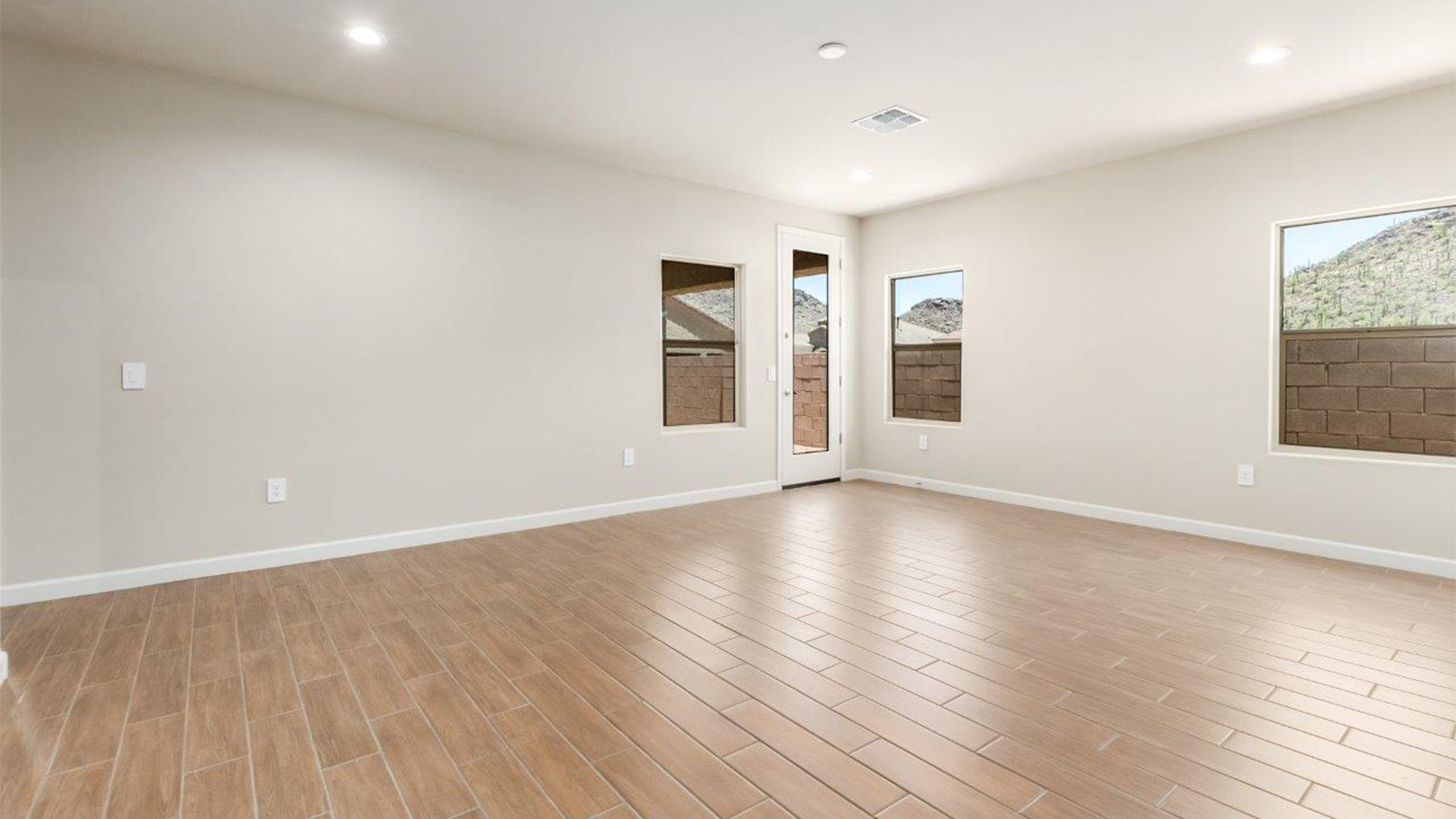 The Lakeway, situated within the beautiful Sycamore Vista community in Vail, Arizona, offers a perfect blend of functionality and comfort, ideal for both growing families and those who appreciate spacious living. With its 2,034 square feet of living space, this single-story new home features five bedrooms and three bathrooms, all meticulously designed to maximize space and convenience.  Entering The Lakeway, you’ll immediately notice the bright and airy atmosphere that flows through the open-concept floor plan. The heart of the home is the great room, seamlessly connected to the kitchen and dining area. The kitchen is equipped with quartz countertops, Shaker-style cabinetry, and a large island that serves as a focal point for both meal preparation and casual gatherings.  The primary bedroom is a true retreat, offering a spacious walk-in closet and an en-suite bathroom. The additional bedrooms are thoughtfully spaced to provide ample privacy for family members or guests, and the two secondary bathrooms are finished with modern fixtures and plenty of storage. This home offers a 2-3 car garage option for substantial space of vehicles and storage, accommodating the practical needs of busy households.  Standard features in The Lakeway at Sycamore Vista include energy-efficient elements like a tankless water heater, spray foam insulation, and LED lighting throughout. The home also comes with a Home is Connected® Smart Home package, which includes a smart thermostat, video doorbell, keyless entry, and more, ensuring modern conveniences are at your fingertips. The front yard is beautifully landscaped and includes an auto drip irrigation system, enhancing the curb appeal of this stunning home.  Nestled within Sycamore Vista, The Lakeway combines the tranquility of a rural setting with proximity to excellent schools, shopping, dining, and outdoor recreation, making it an exceptional place to call home.