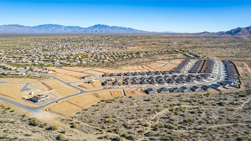 Welcome to Sycamore Vista, a serene new home community by D.R. Horton, nestled in the picturesque foothills of the Santa Rita Mountains. This new phase of Sycamore Vista offers seven thoughtfully designed, single-story floor plans, perfectly paired with breathtaking mountain views and stunning sunsets. Located in the highly sought-after Vail School District, Sycamore Vista is just around the corner from Corona Foothills Middle School, Sycamore Elementary School, and Copper Ridge Elementary School, making it an ideal choice for families. Each new home at Sycamore Vista is crafted with spacious living in mind, featuring large backyards, 3-car garage options, and wide spaces between neighbors, ensuring privacy and tranquility. The homes come with beautifully landscaped front yards equipped with auto drip irrigation systems and soft water loops, adding both convenience and beauty to your outdoor spaces. Enjoy easy access to your outdoor living area through the 6x8 ft backdoor sliders that lead to the back patio, perfect for entertaining or simply relaxing. Additionally, many homes offer double gate options to the backyard, providing extra convenience for accessing and utilizing your expansive yard. Inside, you'll find luxury finishes, including staggered wood-look ceramic tile flooring throughout most areas, granite countertops in the kitchens and bathrooms, and Shaker-style cabinets. The open, single basin stainless steel kitchen sinks, paired with water filtration systems, enhance the functionality and style of your kitchen. Energy efficiency is at the forefront of Sycamore Vista’s new homes. Each home is a DOE Zero Energy Ready Home, featuring spray foam insulation, tankless water heaters, and LED lighting throughout, ensuring lower energy costs and a smaller carbon footprint. The Home is Connected® Smart Home package includes a smart thermostat, video doorbell, keyless entry, and a wifi-enabled garage door opener and more, offering modern conveniences that simplify daily life. With its higher elevation, the community enjoys cooler summer temperatures and less light pollution, making it a perfect spot for stargazing. Outdoor enthusiasts will appreciate the proximity to local, state, and national parks, including Coronado National Forest, Colossal Cave Mountain Park, and Kartchner Caverns State Park, offering endless opportunities for hiking, biking, and camping. Sycamore Vista is ideally located for those who value both tranquility and convenience. This community is a peaceful retreat from the hustle and bustle of city life, yet still provides easy access to shopping, dining, and major employers like the Target Distribution Center and the Amazon Fulfillment Center. Sycamore Vista is just minutes away from major highways, providing easy access to Tucson’s vibrant city life while allowing you to return home to a peaceful, rural setting. Experience the best of Arizona living at Sycamore Vista, where quality craftsmanship, modern amenities, and the beauty of nature come together to create the perfect place to call home.