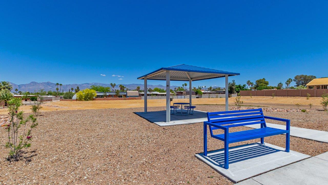 Step into The Baxter at Casas del Cerrito in Tucson, Arizona – a beautifully designed 1,423 sq. ft. single-story new home that perfectly blends modern convenience with the serene beauty of the surrounding desert landscape.  As you enter through the welcoming front porch, you’re greeted by a thoughtfully planned entryway that leads into the heart of the home – a spacious and open-concept great room. This central living area flows seamlessly into the dining space, creating an ideal environment for both entertaining and everyday family life.  The gourmet kitchen, situated adjacent to the dining room, features elegant granite countertops, a large island with a breakfast bar, modern appliances, and a walk-in pantry, providing ample storage and a perfect space for culinary creativity.  The master suite, located at the rear of the home for added privacy, offers a generous walk-in closet and a luxurious en-suite bathroom with dual vanities and a walk-in shower. Large windows allow plenty of natural light to fill the space, creating a tranquil retreat.  Two additional bedrooms are positioned near the front of the home, each with easy access to a full bathroom. These rooms are perfect for family members, guests, or a home office, offering flexibility to suit your lifestyle.  For added convenience, the home includes a utility room and a two-car garage, ensuring that daily routines are efficient and organized.  Step outside to the covered patio, where you can relax and enjoy the stunning mountain views and Tucson’s beautiful weather year-round. Whether you’re hosting a weekend barbecue or enjoying a quiet evening outdoors, this space extends your living area into the peaceful surroundings of Casas del Cerrito.  Designed with energy efficiency in mind, The Baxter at Casas del Cerrito is a DOE Zero Energy Ready Home, ensuring long-term savings and a sustainable living environment.