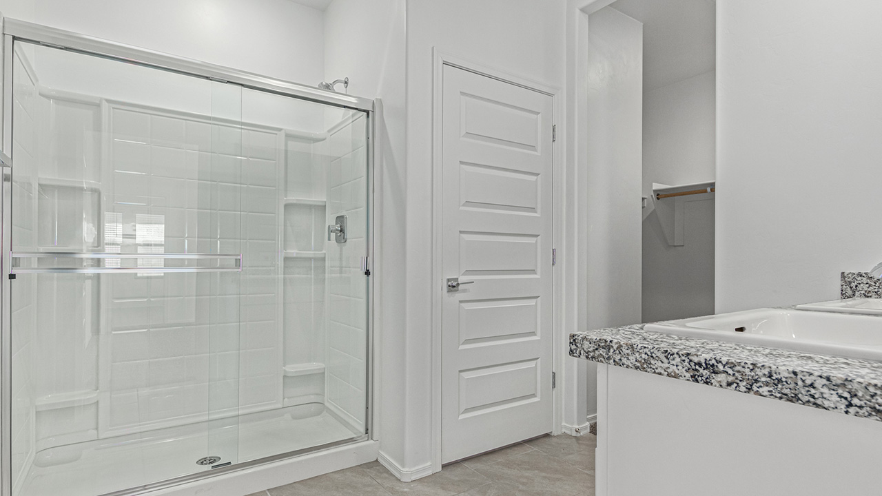 Step into The Baxter at Casas del Cerrito in Tucson, Arizona – a beautifully designed 1,423 sq. ft. single-story new home that perfectly blends modern convenience with the serene beauty of the surrounding desert landscape.  As you enter through the welcoming front porch, you’re greeted by a thoughtfully planned entryway that leads into the heart of the home – a spacious and open-concept great room. This central living area flows seamlessly into the dining space, creating an ideal environment for both entertaining and everyday family life.  The gourmet kitchen, situated adjacent to the dining room, features elegant granite countertops, a large island with a breakfast bar, modern appliances, and a walk-in pantry, providing ample storage and a perfect space for culinary creativity.  The master suite, located at the rear of the home for added privacy, offers a generous walk-in closet and a luxurious en-suite bathroom with dual vanities and a walk-in shower. Large windows allow plenty of natural light to fill the space, creating a tranquil retreat.  Two additional bedrooms are positioned near the front of the home, each with easy access to a full bathroom. These rooms are perfect for family members, guests, or a home office, offering flexibility to suit your lifestyle.  For added convenience, the home includes a utility room and a two-car garage, ensuring that daily routines are efficient and organized.  Step outside to the covered patio, where you can relax and enjoy the stunning mountain views and Tucson’s beautiful weather year-round. Whether you’re hosting a weekend barbecue or enjoying a quiet evening outdoors, this space extends your living area into the peaceful surroundings of Casas del Cerrito.  Designed with energy efficiency in mind, The Baxter at Casas del Cerrito is a DOE Zero Energy Ready Home, ensuring long-term savings and a sustainable living environment.