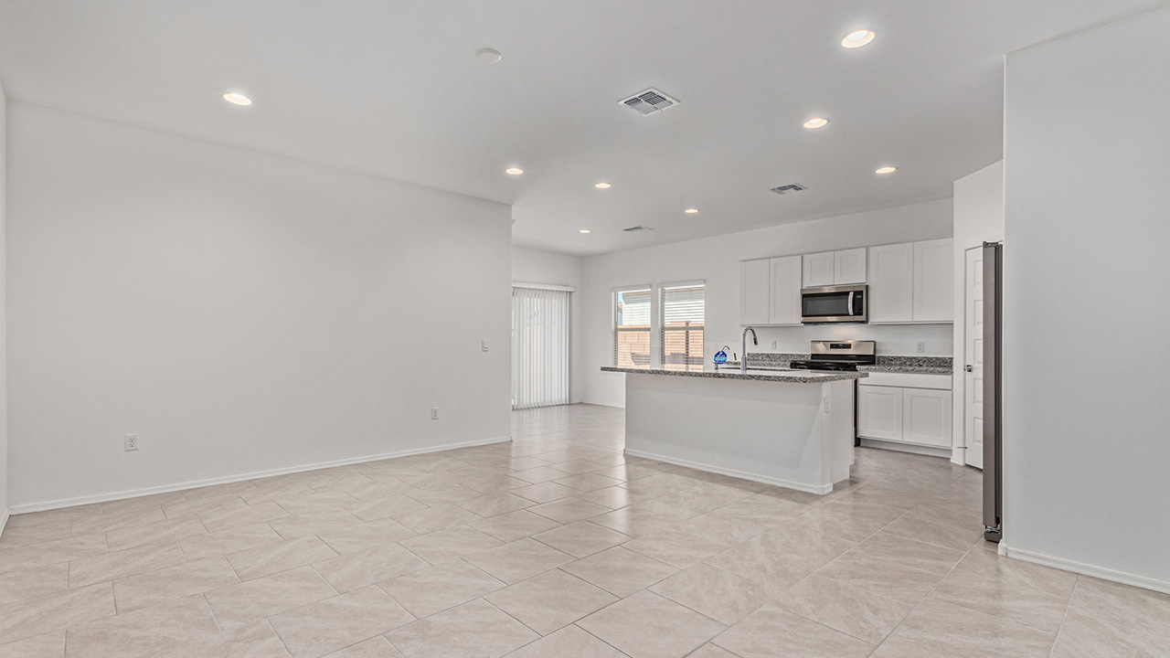 Step into The Baxter at Casas del Cerrito in Tucson, Arizona – a beautifully designed 1,423 sq. ft. single-story new home that perfectly blends modern convenience with the serene beauty of the surrounding desert landscape.  As you enter through the welcoming front porch, you’re greeted by a thoughtfully planned entryway that leads into the heart of the home – a spacious and open-concept great room. This central living area flows seamlessly into the dining space, creating an ideal environment for both entertaining and everyday family life.  The gourmet kitchen, situated adjacent to the dining room, features elegant granite countertops, a large island with a breakfast bar, modern appliances, and a walk-in pantry, providing ample storage and a perfect space for culinary creativity.  The master suite, located at the rear of the home for added privacy, offers a generous walk-in closet and a luxurious en-suite bathroom with dual vanities and a walk-in shower. Large windows allow plenty of natural light to fill the space, creating a tranquil retreat.  Two additional bedrooms are positioned near the front of the home, each with easy access to a full bathroom. These rooms are perfect for family members, guests, or a home office, offering flexibility to suit your lifestyle.  For added convenience, the home includes a utility room and a two-car garage, ensuring that daily routines are efficient and organized.  Step outside to the covered patio, where you can relax and enjoy the stunning mountain views and Tucson’s beautiful weather year-round. Whether you’re hosting a weekend barbecue or enjoying a quiet evening outdoors, this space extends your living area into the peaceful surroundings of Casas del Cerrito.  Designed with energy efficiency in mind, The Baxter at Casas del Cerrito is a DOE Zero Energy Ready Home, ensuring long-term savings and a sustainable living environment.