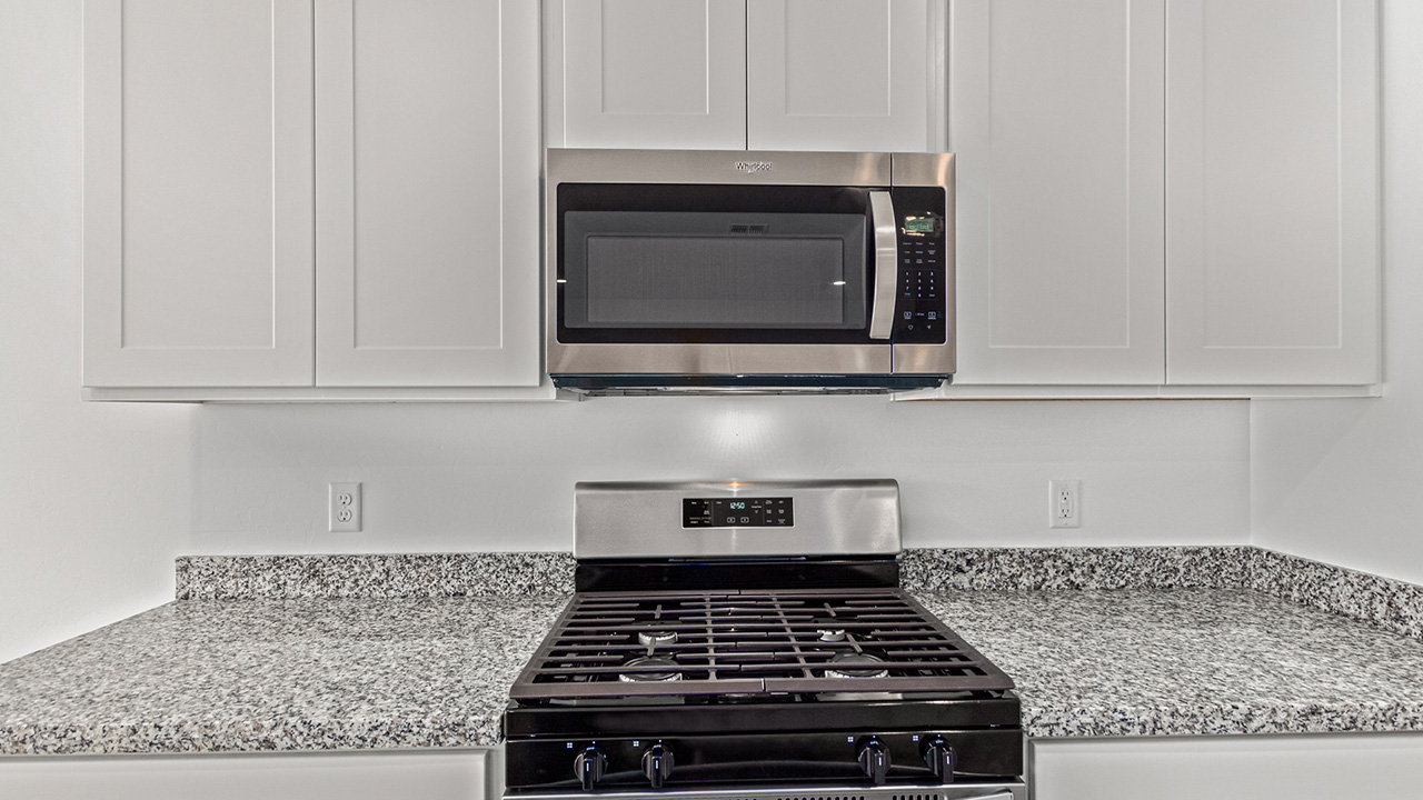 Step into The Baxter at Casas del Cerrito in Tucson, Arizona – a beautifully designed 1,423 sq. ft. single-story new home that perfectly blends modern convenience with the serene beauty of the surrounding desert landscape.  As you enter through the welcoming front porch, you’re greeted by a thoughtfully planned entryway that leads into the heart of the home – a spacious and open-concept great room. This central living area flows seamlessly into the dining space, creating an ideal environment for both entertaining and everyday family life.  The gourmet kitchen, situated adjacent to the dining room, features elegant granite countertops, a large island with a breakfast bar, modern appliances, and a walk-in pantry, providing ample storage and a perfect space for culinary creativity.  The master suite, located at the rear of the home for added privacy, offers a generous walk-in closet and a luxurious en-suite bathroom with dual vanities and a walk-in shower. Large windows allow plenty of natural light to fill the space, creating a tranquil retreat.  Two additional bedrooms are positioned near the front of the home, each with easy access to a full bathroom. These rooms are perfect for family members, guests, or a home office, offering flexibility to suit your lifestyle.  For added convenience, the home includes a utility room and a two-car garage, ensuring that daily routines are efficient and organized.  Step outside to the covered patio, where you can relax and enjoy the stunning mountain views and Tucson’s beautiful weather year-round. Whether you’re hosting a weekend barbecue or enjoying a quiet evening outdoors, this space extends your living area into the peaceful surroundings of Casas del Cerrito.  Designed with energy efficiency in mind, The Baxter at Casas del Cerrito is a DOE Zero Energy Ready Home, ensuring long-term savings and a sustainable living environment.