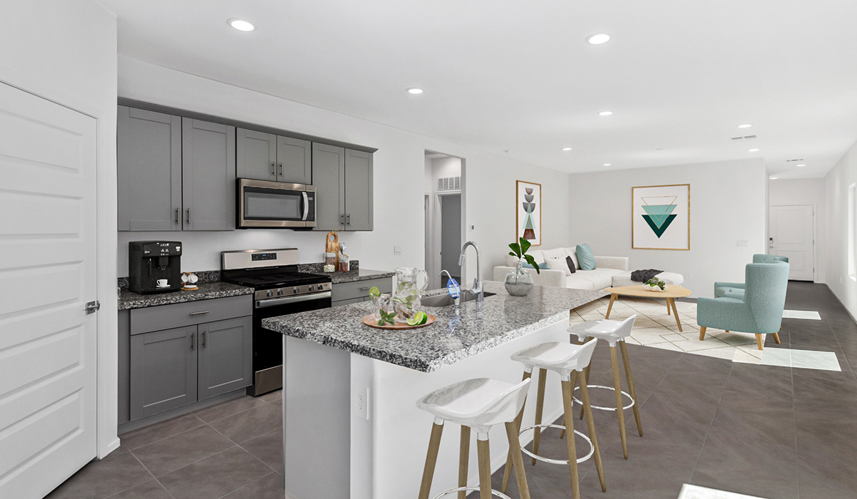 Discover The Diana, a well-planned single-story new home in the vibrant Senita Crossing community. Spanning 1,558 square feet, this residence offers three bedrooms and two bathrooms, all within a layout that emphasizes comfort and ease of living.  As you enter through the front porch, you're greeted by a welcoming foyer that opens into the sprawling great room. This space, designed to be the heart of the home, flows effortlessly into the dining area and kitchen, making it ideal for both everyday living and entertaining. The kitchen is outfitted with a large island, granite countertops, and stylish Shaker-style cabinetry, combining practicality with a touch of sophistication. A generous pantry ensures that storage is never an issue, and stainless steel appliances, including a gas range, microwave, and dishwasher, are all standard, enhancing your cooking experience.  The primary bedroom is thoughtfully located at the rear of the home, providing a private retreat complete with a spacious walk-in closet and an en-suite bathroom featuring dual vanities. The additional two bedrooms are positioned at the opposite end of the home, each with easy access to the second bathroom, making this layout perfect for families or guests.  Outdoor living is a key feature of The Diana, with a covered patio that extends your living space to the outside. Whether you’re enjoying a quiet morning coffee or hosting an evening gathering, this space is perfect for taking advantage of Tucson’s beautiful weather.  Senita Crossing is a community that blends convenience with comfort. Located on Tucson’s southeast side, residents enjoy easy access to I-10, Davis-Monthan Air Force Base, and major employers like Raytheon, making it an ideal location for both families and professionals. Inside The Diana, modern conveniences like 12”x12” ceramic tile flooring, granite countertops, and stainless steel appliances are standard, ensuring that your home is as functional as it is beautiful.  Energy efficiency is a priority in The Diana, with features like a tankless water heater, LED lighting, and advanced spray foam insulation, all contributing to lower energy costs and a smaller carbon footprint. The home is also equipped with D.R. Horton’s Home is Connected® Smart Home package, which includes a smart thermostat, video doorbell, keyless entry, and more, providing both convenience and peace of mind.  Living in Senita Crossing means access to top-rated schools in the Sunnyside Unified School District, as well as proximity to outdoor destinations like Sabino Canyon and cultural attractions like the Tucson Botanical Gardens. The community offers amenities such as a park, playground, and maintained walking and biking trails, making it a perfect place for families to thrive.  The Diana at Senita Crossing is more than just a home; it’s a place where comfort, convenience, and modern living come together to create the perfect environment for you and your family.