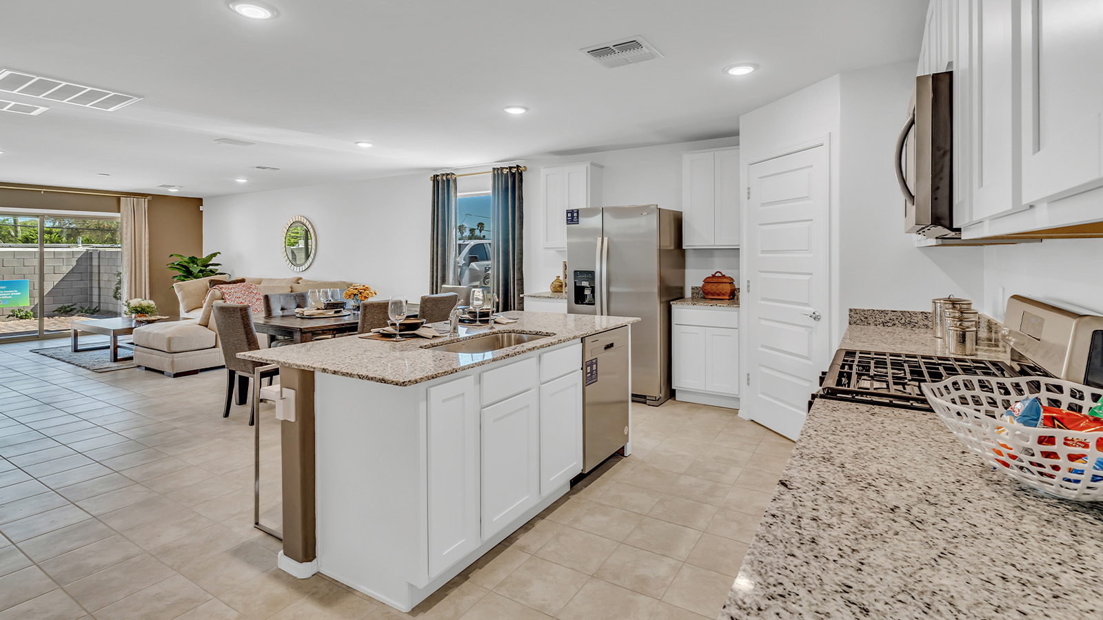 Step into The Gaven, a thoughtfully designed single-story new home nestled within the inviting Senita Crossing community. With 1,776 square feet of living space, this home offers four bedrooms and two bathrooms, ideal for those seeking a blend of functionality and modern style.  As you enter through the front porch, the foyer opens up to reveal a spacious and open layout that flows seamlessly from the entryway to the living areas. The great room serves as the heart of the home, connecting effortlessly to the dining area and kitchen, making it a perfect space for both relaxation and entertaining. The kitchen is a chef's delight, featuring a central island, granite countertops, and Shaker-style cabinetry, providing ample storage and a sleek, modern aesthetic. A large pantry adds to the kitchen’s practicality, ensuring all your culinary essentials are close at hand.  The primary bedroom is strategically placed at the rear of the home, offering a private and serene space complete with a walk-in closet and an en-suite bathroom featuring dual vanities and a spacious shower. The additional three bedrooms are situated toward the front of the home, sharing a full bathroom, making this layout ideal for families or hosting guests.  One of the highlights of The Gaven is its outdoor living space. The covered patio extends from the great room, offering an ideal spot to enjoy Tucson’s beautiful weather. Whether you’re hosting a barbecue, enjoying a quiet morning coffee, or simply relaxing outdoors, this space is designed to enhance your living experience.  Located in the thriving Senita Crossing community on Tucson’s southeast side, residents of The Gaven enjoy a variety of amenities designed for modern living. The community offers easy access to I-10, making commuting a breeze, and is conveniently situated near Davis-Monthan Air Force Base, Raytheon, and the University of Arizona, making it an ideal location for both families and professionals.   Inside The Gaven, you’ll find modern conveniences like 12”x12” ceramic tile flooring, granite countertops, and stainless steel appliances, including a gas range, microwave, and dishwasher. The Home is Connected® Smart Home package, featuring a smart thermostat, video doorbell, and keyless entry, ensures that your home is as functional as it is stylish.  Energy efficiency is a priority at Senita Crossing, with homes that meet DOE Zero Energy Ready standards. Features like tankless water heaters, LED lighting, and advanced spray foam insulation contribute to lower energy costs and a smaller carbon footprint, offering you a sustainable and cost-effective living environment.  Senita Crossing also boasts family-friendly amenities, including a park with a playground, a ramada, and a grassy common area, as well as a maintained bike and walking trail that connects to McCain Loop. The community is served by the highly regarded Sunnyside Unified School District, offering access to top-rated schools, ensuring a bright future for the young ones.  The Gaven at Senita Crossing is more than just a home—it’s a place where comfort, style, and modern living come together to create the perfect environment for you and your family.