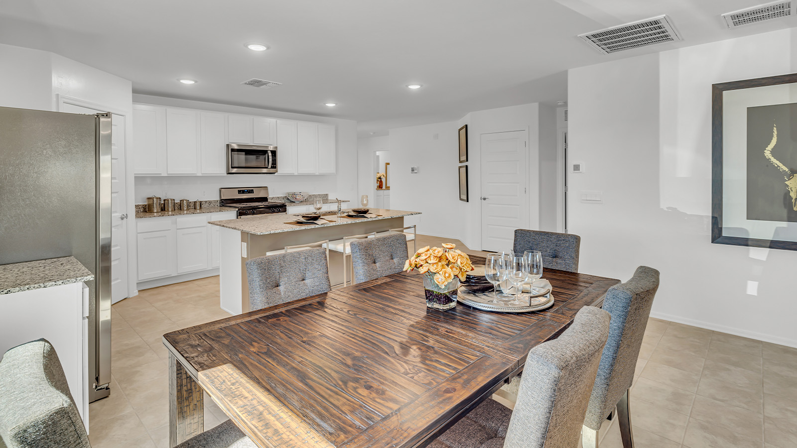 Step into The Gaven, a thoughtfully designed single-story new home nestled within the inviting Senita Crossing community. With 1,776 square feet of living space, this home offers four bedrooms and two bathrooms, ideal for those seeking a blend of functionality and modern style.  As you enter through the front porch, the foyer opens up to reveal a spacious and open layout that flows seamlessly from the entryway to the living areas. The great room serves as the heart of the home, connecting effortlessly to the dining area and kitchen, making it a perfect space for both relaxation and entertaining. The kitchen is a chef's delight, featuring a central island, granite countertops, and Shaker-style cabinetry, providing ample storage and a sleek, modern aesthetic. A large pantry adds to the kitchen’s practicality, ensuring all your culinary essentials are close at hand.  The primary bedroom is strategically placed at the rear of the home, offering a private and serene space complete with a walk-in closet and an en-suite bathroom featuring dual vanities and a spacious shower. The additional three bedrooms are situated toward the front of the home, sharing a full bathroom, making this layout ideal for families or hosting guests.  One of the highlights of The Gaven is its outdoor living space. The covered patio extends from the great room, offering an ideal spot to enjoy Tucson’s beautiful weather. Whether you’re hosting a barbecue, enjoying a quiet morning coffee, or simply relaxing outdoors, this space is designed to enhance your living experience.  Located in the thriving Senita Crossing community on Tucson’s southeast side, residents of The Gaven enjoy a variety of amenities designed for modern living. The community offers easy access to I-10, making commuting a breeze, and is conveniently situated near Davis-Monthan Air Force Base, Raytheon, and the University of Arizona, making it an ideal location for both families and professionals.   Inside The Gaven, you’ll find modern conveniences like 12”x12” ceramic tile flooring, granite countertops, and stainless steel appliances, including a gas range, microwave, and dishwasher. The Home is Connected® Smart Home package, featuring a smart thermostat, video doorbell, and keyless entry, ensures that your home is as functional as it is stylish.  Energy efficiency is a priority at Senita Crossing, with homes that meet DOE Zero Energy Ready standards. Features like tankless water heaters, LED lighting, and advanced spray foam insulation contribute to lower energy costs and a smaller carbon footprint, offering you a sustainable and cost-effective living environment.  Senita Crossing also boasts family-friendly amenities, including a park with a playground, a ramada, and a grassy common area, as well as a maintained bike and walking trail that connects to McCain Loop. The community is served by the highly regarded Sunnyside Unified School District, offering access to top-rated schools, ensuring a bright future for the young ones.  The Gaven at Senita Crossing is more than just a home—it’s a place where comfort, style, and modern living come together to create the perfect environment for you and your family.