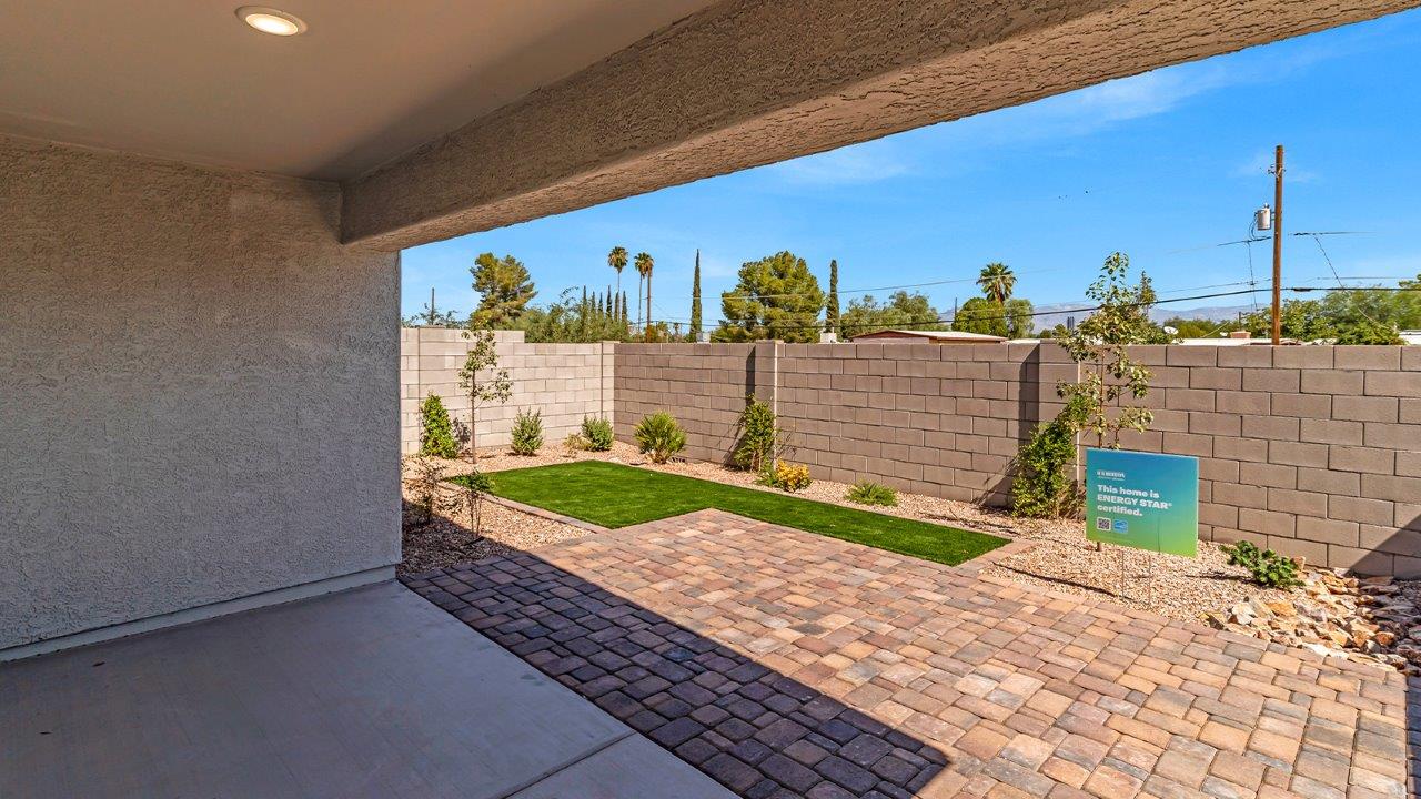 Step into The Gaven, a thoughtfully designed single-story new home nestled within the inviting Senita Crossing community. With 1,776 square feet of living space, this home offers four bedrooms and two bathrooms, ideal for those seeking a blend of functionality and modern style.  As you enter through the front porch, the foyer opens up to reveal a spacious and open layout that flows seamlessly from the entryway to the living areas. The great room serves as the heart of the home, connecting effortlessly to the dining area and kitchen, making it a perfect space for both relaxation and entertaining. The kitchen is a chef's delight, featuring a central island, granite countertops, and Shaker-style cabinetry, providing ample storage and a sleek, modern aesthetic. A large pantry adds to the kitchen’s practicality, ensuring all your culinary essentials are close at hand.  The primary bedroom is strategically placed at the rear of the home, offering a private and serene space complete with a walk-in closet and an en-suite bathroom featuring dual vanities and a spacious shower. The additional three bedrooms are situated toward the front of the home, sharing a full bathroom, making this layout ideal for families or hosting guests.  One of the highlights of The Gaven is its outdoor living space. The covered patio extends from the great room, offering an ideal spot to enjoy Tucson’s beautiful weather. Whether you’re hosting a barbecue, enjoying a quiet morning coffee, or simply relaxing outdoors, this space is designed to enhance your living experience.  Located in the thriving Senita Crossing community on Tucson’s southeast side, residents of The Gaven enjoy a variety of amenities designed for modern living. The community offers easy access to I-10, making commuting a breeze, and is conveniently situated near Davis-Monthan Air Force Base, Raytheon, and the University of Arizona, making it an ideal location for both families and professionals.   Inside The Gaven, you’ll find modern conveniences like 12”x12” ceramic tile flooring, granite countertops, and stainless steel appliances, including a gas range, microwave, and dishwasher. The Home is Connected® Smart Home package, featuring a smart thermostat, video doorbell, and keyless entry, ensures that your home is as functional as it is stylish.  Energy efficiency is a priority at Senita Crossing, with homes that meet DOE Zero Energy Ready standards. Features like tankless water heaters, LED lighting, and advanced spray foam insulation contribute to lower energy costs and a smaller carbon footprint, offering you a sustainable and cost-effective living environment.  Senita Crossing also boasts family-friendly amenities, including a park with a playground, a ramada, and a grassy common area, as well as a maintained bike and walking trail that connects to McCain Loop. The community is served by the highly regarded Sunnyside Unified School District, offering access to top-rated schools, ensuring a bright future for the young ones.  The Gaven at Senita Crossing is more than just a home—it’s a place where comfort, style, and modern living come together to create the perfect environment for you and your family.