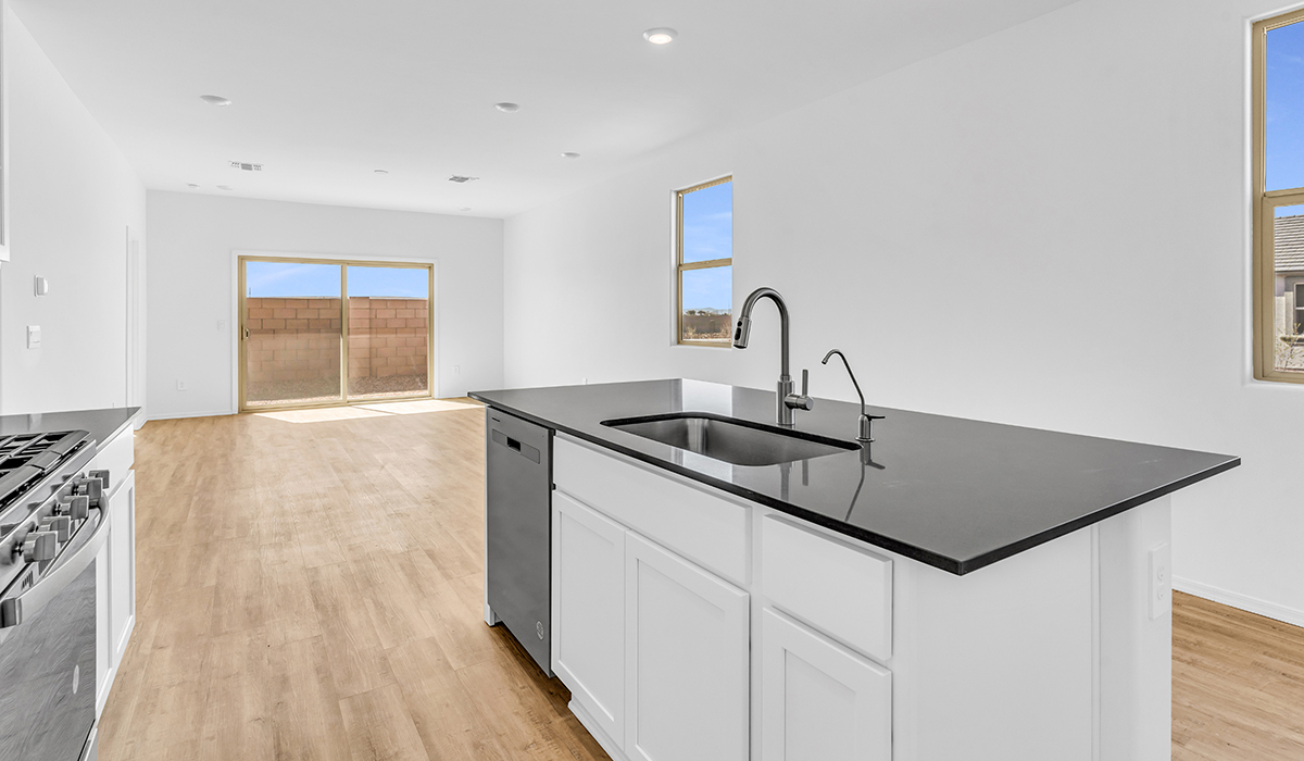 Welcome to The Amber at Blackhawk in Tucson, Arizona – a charming 1,331 sq. ft. single-story new home designed to offer both comfort and style in a prime location.  As you step through the front porch, you're greeted by an inviting entryway that opens up into a beautifully designed living space. The great room serves as the heart of the home, providing a spacious area for relaxing, entertaining, or enjoying family time. This open-concept design flows seamlessly into the dining area and kitchen.  The kitchen is a true centerpiece, featuring elegant quartz countertops, modern appliances, a pantry for ample storage, and a convenient breakfast bar. Whether you’re preparing a quick meal or hosting a dinner party, this kitchen is equipped to meet your needs with both style and functionality.  Just off the great room, you’ll find the primary bedroom – a private retreat designed for relaxation. The primary bedroom is generously sized and includes a walk-in closet and an en-suite bathroom, offering both luxury and convenience.   The Amber also includes two additional bedrooms, well-positioned to share a full bathroom. These rooms are ideal for family members, guests, or even a home office.  For added convenience, the home includes a utility room located near the bedrooms, and a two-car garage that offers both storage and functionality. Step outside to the covered patio, where you can unwind and enjoy Tucson’s beautiful weather year-round. Whether you’re sipping your morning coffee or hosting a weekend barbecue, this outdoor space extends your living area into the serene surroundings of Blackhawk.  Designed with energy efficiency in mind, The Amber at Blackhawk is a DOE Zero Energy Ready Home, ensuring long-term savings and a sustainable living environment.  *Images shown are for reference only. They depict the Amber layout and specification home and may not represent the actual home.