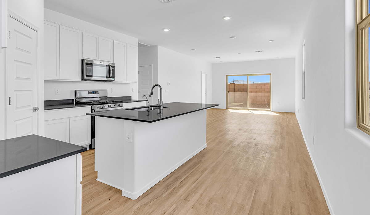 Welcome to The Amber at Blackhawk in Tucson, Arizona – a charming 1,331 sq. ft. single-story new home designed to offer both comfort and style in a prime location.  As you step through the front porch, you're greeted by an inviting entryway that opens up into a beautifully designed living space. The great room serves as the heart of the home, providing a spacious area for relaxing, entertaining, or enjoying family time. This open-concept design flows seamlessly into the dining area and kitchen.  The kitchen is a true centerpiece, featuring elegant quartz countertops, modern appliances, a pantry for ample storage, and a convenient breakfast bar. Whether you’re preparing a quick meal or hosting a dinner party, this kitchen is equipped to meet your needs with both style and functionality.  Just off the great room, you’ll find the primary bedroom – a private retreat designed for relaxation. The primary bedroom is generously sized and includes a walk-in closet and an en-suite bathroom, offering both luxury and convenience.   The Amber also includes two additional bedrooms, well-positioned to share a full bathroom. These rooms are ideal for family members, guests, or even a home office.  For added convenience, the home includes a utility room located near the bedrooms, and a two-car garage that offers both storage and functionality. Step outside to the covered patio, where you can unwind and enjoy Tucson’s beautiful weather year-round. Whether you’re sipping your morning coffee or hosting a weekend barbecue, this outdoor space extends your living area into the serene surroundings of Blackhawk.  Designed with energy efficiency in mind, The Amber at Blackhawk is a DOE Zero Energy Ready Home, ensuring long-term savings and a sustainable living environment.  *Images shown are for reference only. They depict the Amber model and may not represent the actual home.