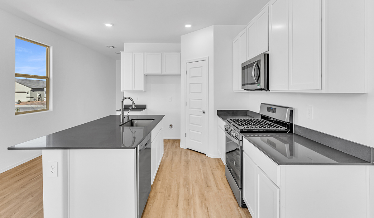 Welcome to The Amber at Blackhawk in Tucson, Arizona – a charming 1,331 sq. ft. single-story new home designed to offer both comfort and style in a prime location.  As you step through the front porch, you're greeted by an inviting entryway that opens up into a beautifully designed living space. The great room serves as the heart of the home, providing a spacious area for relaxing, entertaining, or enjoying family time. This open-concept design flows seamlessly into the dining area and kitchen.  The kitchen is a true centerpiece, featuring elegant quartz countertops, modern appliances, a pantry for ample storage, and a convenient breakfast bar. Whether you’re preparing a quick meal or hosting a dinner party, this kitchen is equipped to meet your needs with both style and functionality.  Just off the great room, you’ll find the primary bedroom – a private retreat designed for relaxation. The primary bedroom is generously sized and includes a walk-in closet and an en-suite bathroom, offering both luxury and convenience.   The Amber also includes two additional bedrooms, well-positioned to share a full bathroom. These rooms are ideal for family members, guests, or even a home office.  For added convenience, the home includes a utility room located near the bedrooms, and a two-car garage that offers both storage and functionality. Step outside to the covered patio, where you can unwind and enjoy Tucson’s beautiful weather year-round. Whether you’re sipping your morning coffee or hosting a weekend barbecue, this outdoor space extends your living area into the serene surroundings of Blackhawk.  Designed with energy efficiency in mind, The Amber at Blackhawk is a DOE Zero Energy Ready Home, ensuring long-term savings and a sustainable living environment.  *Images shown are for reference only. They depict the Amber model and may not represent the actual home.