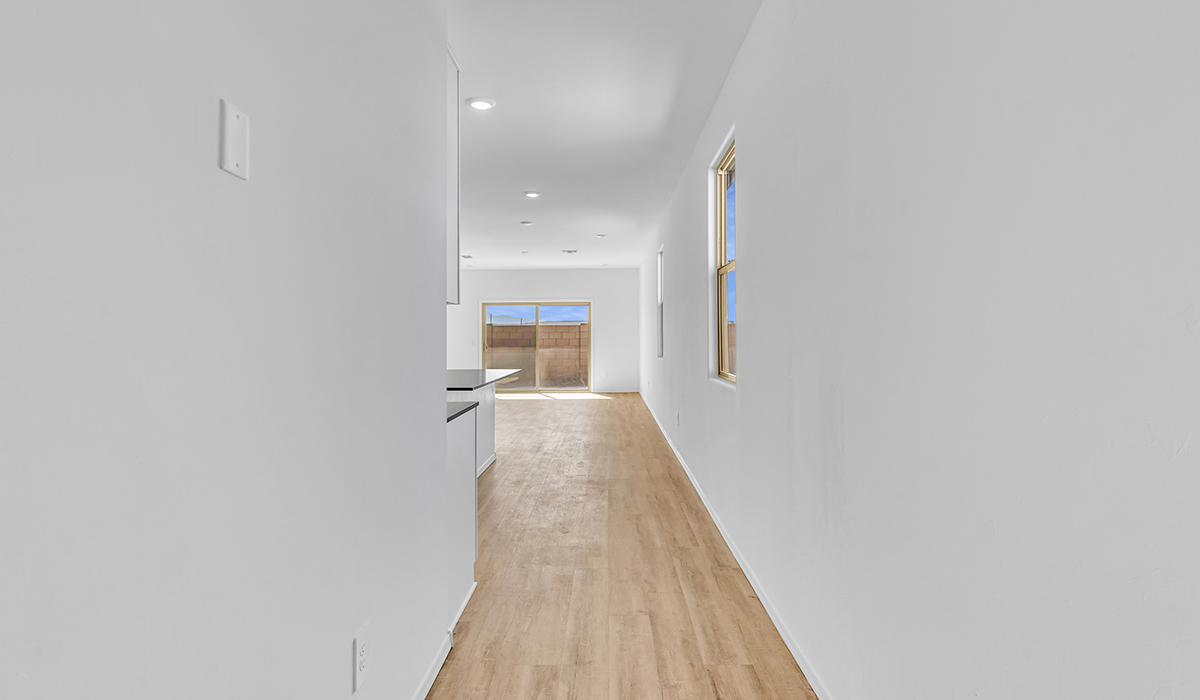 Welcome to The Amber at Blackhawk in Tucson, Arizona – a charming 1,331 sq. ft. single-story new home designed to offer both comfort and style in a prime location.  As you step through the front porch, you're greeted by an inviting entryway that opens up into a beautifully designed living space. The great room serves as the heart of the home, providing a spacious area for relaxing, entertaining, or enjoying family time. This open-concept design flows seamlessly into the dining area and kitchen.  The kitchen is a true centerpiece, featuring elegant quartz countertops, modern appliances, a pantry for ample storage, and a convenient breakfast bar. Whether you’re preparing a quick meal or hosting a dinner party, this kitchen is equipped to meet your needs with both style and functionality.  Just off the great room, you’ll find the primary bedroom – a private retreat designed for relaxation. The primary bedroom is generously sized and includes a walk-in closet and an en-suite bathroom, offering both luxury and convenience.   The Amber also includes two additional bedrooms, well-positioned to share a full bathroom. These rooms are ideal for family members, guests, or even a home office.  For added convenience, the home includes a utility room located near the bedrooms, and a two-car garage that offers both storage and functionality. Step outside to the covered patio, where you can unwind and enjoy Tucson’s beautiful weather year-round. Whether you’re sipping your morning coffee or hosting a weekend barbecue, this outdoor space extends your living area into the serene surroundings of Blackhawk.  Designed with energy efficiency in mind, The Amber at Blackhawk is a DOE Zero Energy Ready Home, ensuring long-term savings and a sustainable living environment.  *Images shown are for reference only. They depict the Amber model and may not represent the actual home.