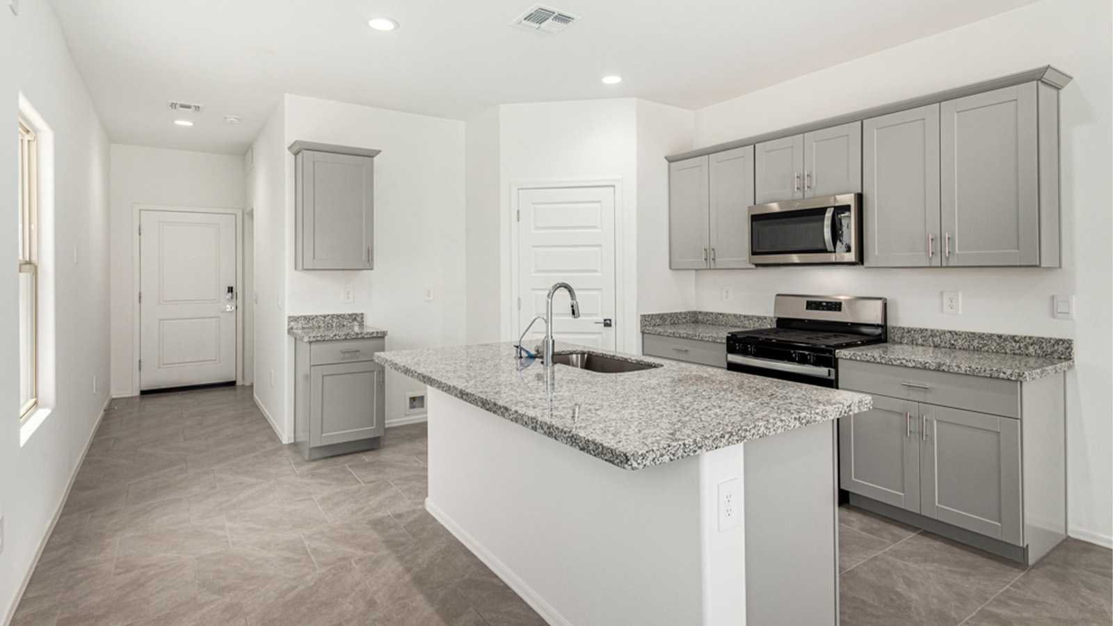 Welcome to The Amber at Blackhawk in Tucson, Arizona – a charming 1,331 sq. ft. single-story new home designed to offer both comfort and style in a prime location.  As you step through the front porch, you're greeted by an inviting entryway that opens up into a beautifully designed living space. The great room serves as the heart of the home, providing a spacious area for relaxing, entertaining, or enjoying family time. This open-concept design flows seamlessly into the dining area and kitchen.  The kitchen is a true centerpiece, featuring elegant quartz countertops, modern appliances, a pantry for ample storage, and a convenient breakfast bar. Whether you’re preparing a quick meal or hosting a dinner party, this kitchen is equipped to meet your needs with both style and functionality.  Just off the great room, you’ll find the primary bedroom – a private retreat designed for relaxation. The primary bedroom is generously sized and includes a walk-in closet and an en-suite bathroom, offering both luxury and convenience.   The Amber also includes two additional bedrooms, well-positioned to share a full bathroom. These rooms are ideal for family members, guests, or even a home office.  For added convenience, the home includes a utility room located near the bedrooms, and a two-car garage that offers both storage and functionality. Step outside to the covered patio, where you can unwind and enjoy Tucson’s beautiful weather year-round. Whether you’re sipping your morning coffee or hosting a weekend barbecue, this outdoor space extends your living area into the serene surroundings of Blackhawk.  Designed with energy efficiency in mind, The Amber at Blackhawk is a DOE Zero Energy Ready Home, ensuring long-term savings and a sustainable living environment.  *Images shown are for reference only. They depict the Amber model and may not represent the actual home.