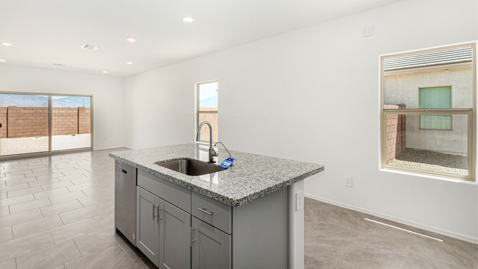 Welcome to The Amber at Blackhawk in Tucson, Arizona – a charming 1,331 sq. ft. single-story new home designed to offer both comfort and style in a prime location.  As you step through the front porch, you're greeted by an inviting entryway that opens up into a beautifully designed living space. The great room serves as the heart of the home, providing a spacious area for relaxing, entertaining, or enjoying family time. This open-concept design flows seamlessly into the dining area and kitchen.  The kitchen is a true centerpiece, featuring elegant quartz countertops, modern appliances, a pantry for ample storage, and a convenient breakfast bar. Whether you’re preparing a quick meal or hosting a dinner party, this kitchen is equipped to meet your needs with both style and functionality.  Just off the great room, you’ll find the primary bedroom – a private retreat designed for relaxation. The primary bedroom is generously sized and includes a walk-in closet and an en-suite bathroom, offering both luxury and convenience.   The Amber also includes two additional bedrooms, well-positioned to share a full bathroom. These rooms are ideal for family members, guests, or even a home office.  For added convenience, the home includes a utility room located near the bedrooms, and a two-car garage that offers both storage and functionality. Step outside to the covered patio, where you can unwind and enjoy Tucson’s beautiful weather year-round. Whether you’re sipping your morning coffee or hosting a weekend barbecue, this outdoor space extends your living area into the serene surroundings of Blackhawk.  Designed with energy efficiency in mind, The Amber at Blackhawk is a DOE Zero Energy Ready Home, ensuring long-term savings and a sustainable living environment.  *Images shown are for reference only. They depict the Amber model and may not represent the actual home.