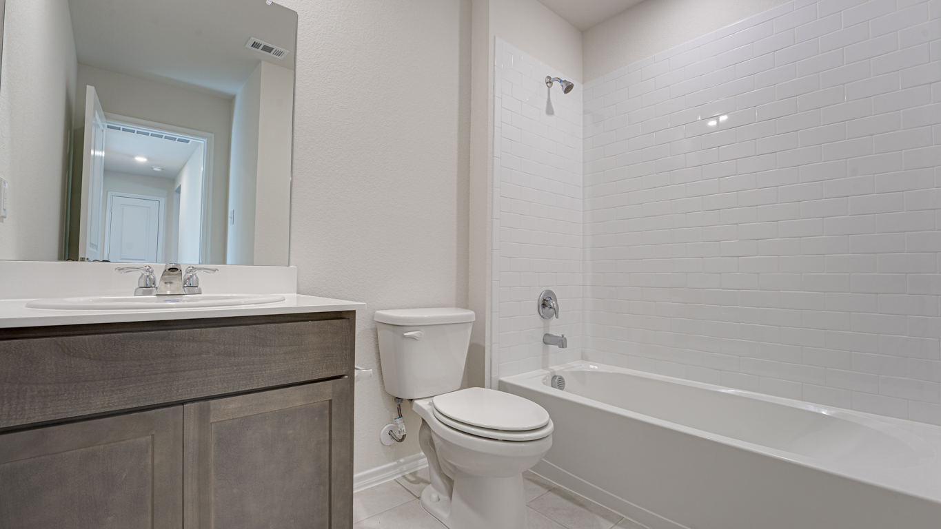 Welcome to The Amber at Blackhawk in Tucson, Arizona – a charming 1,331 sq. ft. single-story new home designed to offer both comfort and style in a prime location.  As you step through the front porch, you're greeted by an inviting entryway that opens up into a beautifully designed living space. The great room serves as the heart of the home, providing a spacious area for relaxing, entertaining, or enjoying family time. This open-concept design flows seamlessly into the dining area and kitchen.  The kitchen is a true centerpiece, featuring elegant quartz countertops, modern appliances, a pantry for ample storage, and a convenient breakfast bar. Whether you’re preparing a quick meal or hosting a dinner party, this kitchen is equipped to meet your needs with both style and functionality.  Just off the great room, you’ll find the primary bedroom – a private retreat designed for relaxation. The primary bedroom is generously sized and includes a walk-in closet and an en-suite bathroom, offering both luxury and convenience.   The Amber also includes two additional bedrooms, well-positioned to share a full bathroom. These rooms are ideal for family members, guests, or even a home office.  For added convenience, the home includes a utility room located near the bedrooms, and a two-car garage that offers both storage and functionality. Step outside to the covered patio, where you can unwind and enjoy Tucson’s beautiful weather year-round. Whether you’re sipping your morning coffee or hosting a weekend barbecue, this outdoor space extends your living area into the serene surroundings of Blackhawk.  Designed with energy efficiency in mind, The Amber at Blackhawk is a DOE Zero Energy Ready Home, ensuring long-term savings and a sustainable living environment.  *Images shown are for reference only. They depict the Amber model and may not represent the actual home.