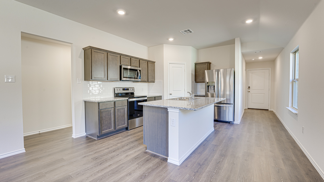 Welcome to The Amber at Blackhawk in Tucson, Arizona – a charming 1,331 sq. ft. single-story new home designed to offer both comfort and style in a prime location.  As you step through the front porch, you're greeted by an inviting entryway that opens up into a beautifully designed living space. The great room serves as the heart of the home, providing a spacious area for relaxing, entertaining, or enjoying family time. This open-concept design flows seamlessly into the dining area and kitchen.  The kitchen is a true centerpiece, featuring elegant quartz countertops, modern appliances, a pantry for ample storage, and a convenient breakfast bar. Whether you’re preparing a quick meal or hosting a dinner party, this kitchen is equipped to meet your needs with both style and functionality.  Just off the great room, you’ll find the primary bedroom – a private retreat designed for relaxation. The primary bedroom is generously sized and includes a walk-in closet and an en-suite bathroom, offering both luxury and convenience.   The Amber also includes two additional bedrooms, well-positioned to share a full bathroom. These rooms are ideal for family members, guests, or even a home office.  For added convenience, the home includes a utility room located near the bedrooms, and a two-car garage that offers both storage and functionality. Step outside to the covered patio, where you can unwind and enjoy Tucson’s beautiful weather year-round. Whether you’re sipping your morning coffee or hosting a weekend barbecue, this outdoor space extends your living area into the serene surroundings of Blackhawk.  Designed with energy efficiency in mind, The Amber at Blackhawk is a DOE Zero Energy Ready Home, ensuring long-term savings and a sustainable living environment.  *Images shown are for reference only. They depict the Amber model and may not represent the actual home.