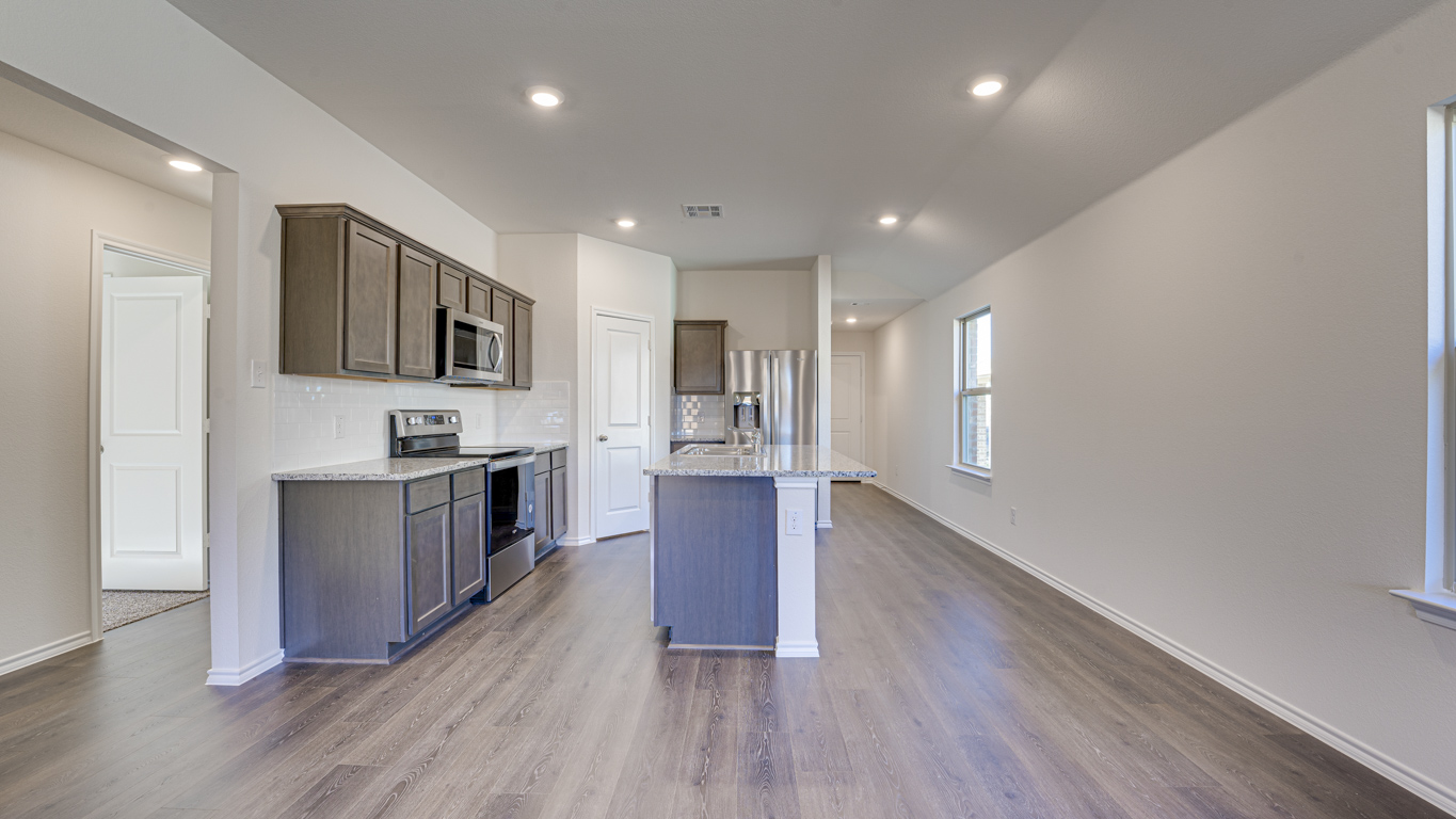 Welcome to The Amber at Blackhawk in Tucson, Arizona – a charming 1,331 sq. ft. single-story new home designed to offer both comfort and style in a prime location.  As you step through the front porch, you're greeted by an inviting entryway that opens up into a beautifully designed living space. The great room serves as the heart of the home, providing a spacious area for relaxing, entertaining, or enjoying family time. This open-concept design flows seamlessly into the dining area and kitchen.  The kitchen is a true centerpiece, featuring elegant quartz countertops, modern appliances, a pantry for ample storage, and a convenient breakfast bar. Whether you’re preparing a quick meal or hosting a dinner party, this kitchen is equipped to meet your needs with both style and functionality.  Just off the great room, you’ll find the primary bedroom – a private retreat designed for relaxation. The primary bedroom is generously sized and includes a walk-in closet and an en-suite bathroom, offering both luxury and convenience.   The Amber also includes two additional bedrooms, well-positioned to share a full bathroom. These rooms are ideal for family members, guests, or even a home office.  For added convenience, the home includes a utility room located near the bedrooms, and a two-car garage that offers both storage and functionality. Step outside to the covered patio, where you can unwind and enjoy Tucson’s beautiful weather year-round. Whether you’re sipping your morning coffee or hosting a weekend barbecue, this outdoor space extends your living area into the serene surroundings of Blackhawk.  Designed with energy efficiency in mind, The Amber at Blackhawk is a DOE Zero Energy Ready Home, ensuring long-term savings and a sustainable living environment.  *Images shown are for reference only. They depict the Amber model and may not represent the actual home.