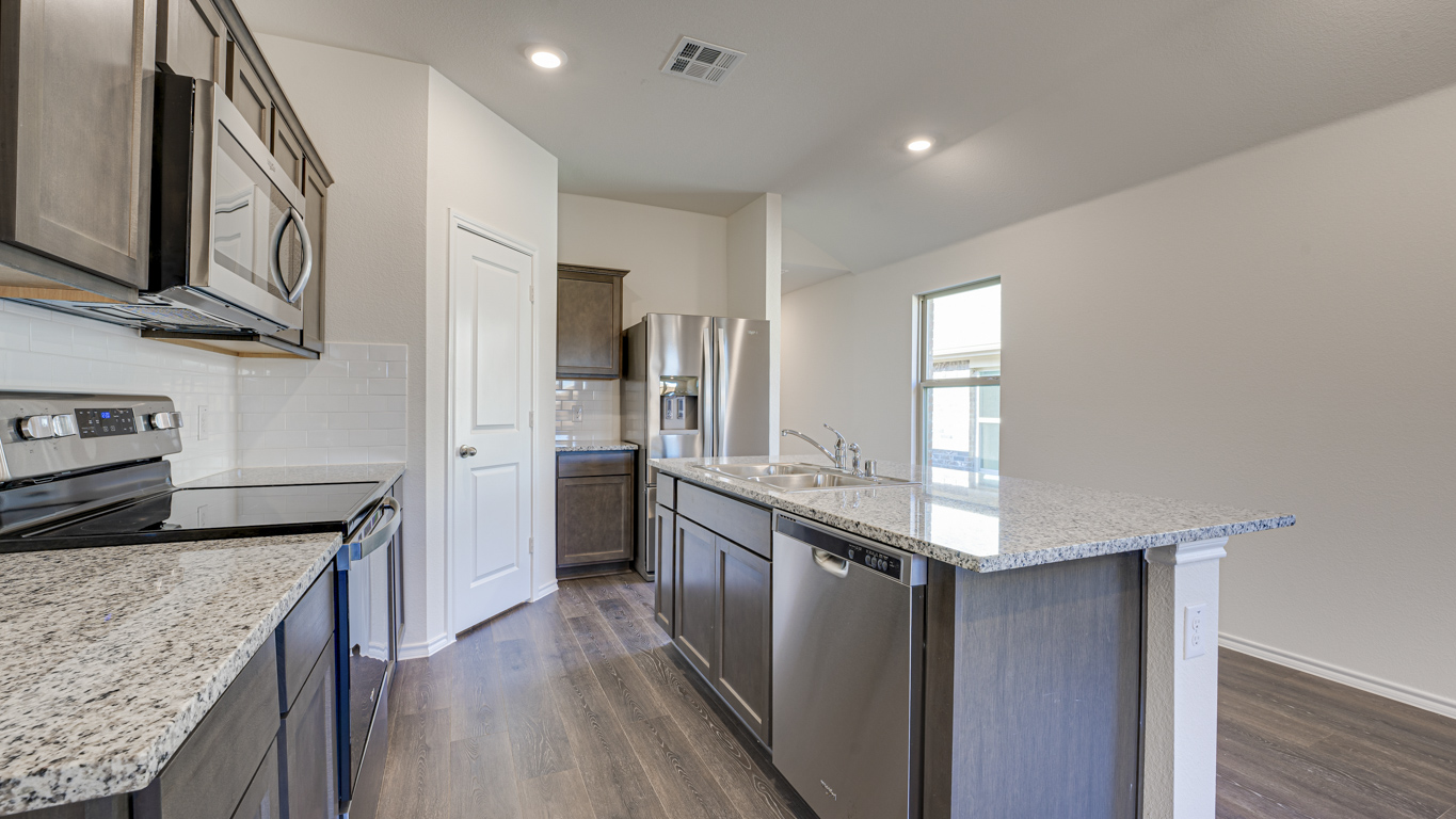 Welcome to The Amber at Blackhawk in Tucson, Arizona – a charming 1,331 sq. ft. single-story new home designed to offer both comfort and style in a prime location.  As you step through the front porch, you're greeted by an inviting entryway that opens up into a beautifully designed living space. The great room serves as the heart of the home, providing a spacious area for relaxing, entertaining, or enjoying family time. This open-concept design flows seamlessly into the dining area and kitchen.  The kitchen is a true centerpiece, featuring elegant quartz countertops, modern appliances, a pantry for ample storage, and a convenient breakfast bar. Whether you’re preparing a quick meal or hosting a dinner party, this kitchen is equipped to meet your needs with both style and functionality.  Just off the great room, you’ll find the primary bedroom – a private retreat designed for relaxation. The primary bedroom is generously sized and includes a walk-in closet and an en-suite bathroom, offering both luxury and convenience.   The Amber also includes two additional bedrooms, well-positioned to share a full bathroom. These rooms are ideal for family members, guests, or even a home office.  For added convenience, the home includes a utility room located near the bedrooms, and a two-car garage that offers both storage and functionality. Step outside to the covered patio, where you can unwind and enjoy Tucson’s beautiful weather year-round. Whether you’re sipping your morning coffee or hosting a weekend barbecue, this outdoor space extends your living area into the serene surroundings of Blackhawk.  Designed with energy efficiency in mind, The Amber at Blackhawk is a DOE Zero Energy Ready Home, ensuring long-term savings and a sustainable living environment.  *Images shown are for reference only. They depict the Amber model and may not represent the actual home.