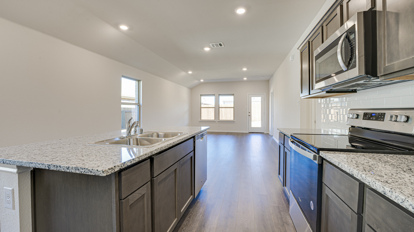 Welcome to The Amber at Blackhawk in Tucson, Arizona – a charming 1,331 sq. ft. single-story new home designed to offer both comfort and style in a prime location.  As you step through the front porch, you're greeted by an inviting entryway that opens up into a beautifully designed living space. The great room serves as the heart of the home, providing a spacious area for relaxing, entertaining, or enjoying family time. This open-concept design flows seamlessly into the dining area and kitchen.  The kitchen is a true centerpiece, featuring elegant quartz countertops, modern appliances, a pantry for ample storage, and a convenient breakfast bar. Whether you’re preparing a quick meal or hosting a dinner party, this kitchen is equipped to meet your needs with both style and functionality.  Just off the great room, you’ll find the primary bedroom – a private retreat designed for relaxation. The primary bedroom is generously sized and includes a walk-in closet and an en-suite bathroom, offering both luxury and convenience.   The Amber also includes two additional bedrooms, well-positioned to share a full bathroom. These rooms are ideal for family members, guests, or even a home office.  For added convenience, the home includes a utility room located near the bedrooms, and a two-car garage that offers both storage and functionality. Step outside to the covered patio, where you can unwind and enjoy Tucson’s beautiful weather year-round. Whether you’re sipping your morning coffee or hosting a weekend barbecue, this outdoor space extends your living area into the serene surroundings of Blackhawk.  Designed with energy efficiency in mind, The Amber at Blackhawk is a DOE Zero Energy Ready Home, ensuring long-term savings and a sustainable living environment.  *Images shown are for reference only. They depict the Amber model and may not represent the actual home.