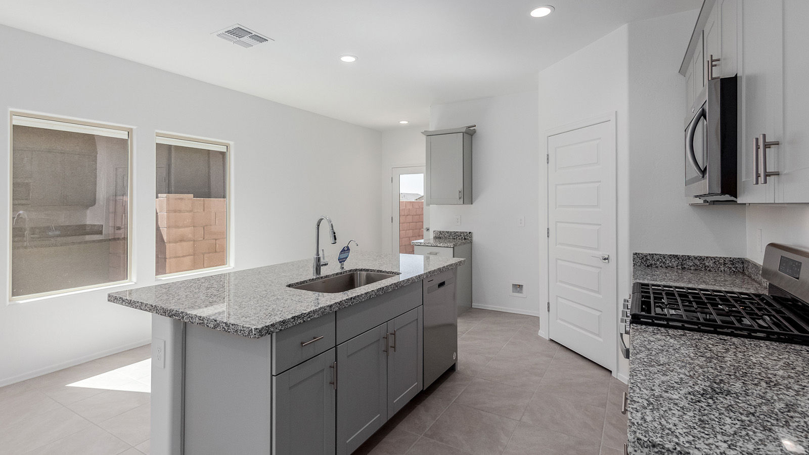 Welcome to The Diana at Blackhawk in Tucson, Arizona – a spacious 1,558 sq. ft. single-story new home designed to offer comfort, style, and energy efficiency in a prime location.  As you enter through the inviting front porch, you're greeted by a well-designed entryway that leads into an open-concept living area. The great room is the centerpiece of the home, providing a generous space for relaxing, entertaining, or enjoying quality time with family. It seamlessly flows into the dining area and kitchen, creating a bright and welcoming atmosphere perfect for any occasion.  The kitchen is thoughtfully designed with modern touches, including elegant granite countertops, a pantry for ample storage, and a large island with a breakfast bar that makes both meal preparation and casual dining a breeze. The open layout ensures that the kitchen is always connected to the rest of the living space, making it easy to interact with family and guests.  Adjacent to the great room, you’ll find the master suite, offering a private retreat within the home. The master bedroom is generously sized, featuring a spacious walk-in closet and an en-suite bathroom with dual vanities and a walk-in shower, providing both luxury and convenience.  The Diana also includes two additional bedrooms, well-positioned to share a full bathroom. These rooms are ideal for family members, guests, or even a home office, offering flexible living options to suit your needs.  A utility room and a two-car garage add to the home’s practicality, ensuring that daily routines are efficient and organized. Step outside to the covered patio, where you can unwind and enjoy Tucson’s beautiful weather, whether it’s a quiet morning coffee or an evening gathering with friends.  Designed with energy efficiency in mind, The Diana at Blackhawk is a DOE Zero Energy Ready Home, ensuring long-term savings and a sustainable living environment.