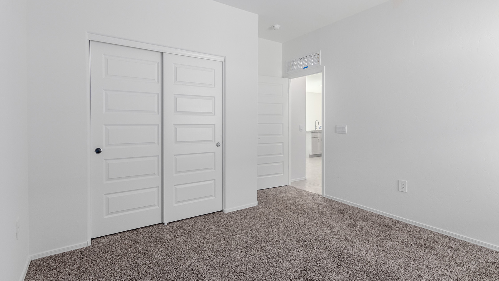 Welcome to The Diana at Blackhawk in Tucson, Arizona – a spacious 1,558 sq. ft. single-story new home designed to offer comfort, style, and energy efficiency in a prime location.  As you enter through the inviting front porch, you're greeted by a well-designed entryway that leads into an open-concept living area. The great room is the centerpiece of the home, providing a generous space for relaxing, entertaining, or enjoying quality time with family. It seamlessly flows into the dining area and kitchen, creating a bright and welcoming atmosphere perfect for any occasion.  The kitchen is thoughtfully designed with modern touches, including elegant granite countertops, a pantry for ample storage, and a large island with a breakfast bar that makes both meal preparation and casual dining a breeze. The open layout ensures that the kitchen is always connected to the rest of the living space, making it easy to interact with family and guests.  Adjacent to the great room, you’ll find the master suite, offering a private retreat within the home. The master bedroom is generously sized, featuring a spacious walk-in closet and an en-suite bathroom with dual vanities and a walk-in shower, providing both luxury and convenience.  The Diana also includes two additional bedrooms, well-positioned to share a full bathroom. These rooms are ideal for family members, guests, or even a home office, offering flexible living options to suit your needs.  A utility room and a two-car garage add to the home’s practicality, ensuring that daily routines are efficient and organized. Step outside to the covered patio, where you can unwind and enjoy Tucson’s beautiful weather, whether it’s a quiet morning coffee or an evening gathering with friends.  Designed with energy efficiency in mind, The Diana at Blackhawk is a DOE Zero Energy Ready Home, ensuring long-term savings and a sustainable living environment.