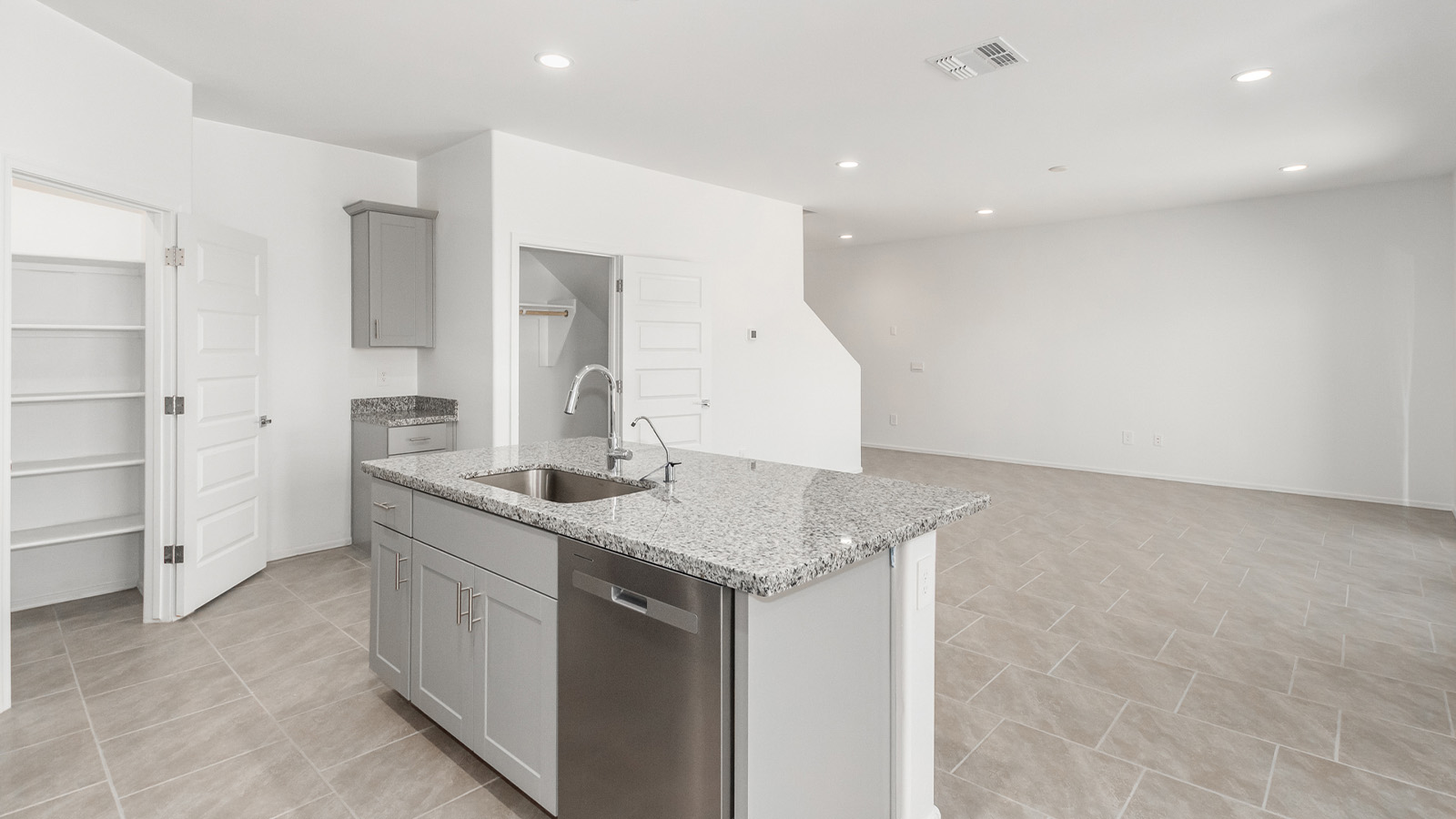 Introducing The Grace at Blackhawk in Tucson, Arizona – a spacious 1,963 sq. ft. two-story new home designed to accommodate modern living with style and functionality.  As you step through the welcoming front porch, you’re greeted by an open and inviting entryway that leads directly into the heart of the home. The main level features a spacious great room that flows seamlessly into the dining area and the modern kitchen, creating a perfect space for entertaining and family gatherings. The kitchen is equipped with elegant granite countertops, a large island with a breakfast bar, modern appliances, and a pantry that offers plenty of storage, making it as functional as it is stylish.  The main floor also includes a convenient powder room for guests, and direct access to the two-car garage, enhancing the home’s functionality and ease of living.  Heading upstairs, you'll discover the family’s private quarters. The master suite is a serene retreat, featuring a generously sized bedroom, a large walk-in closet, and an en-suite bathroom complete with dual vanities and a walk-in shower. The upper level also includes three additional bedrooms, a full bathroom, and a utility room conveniently located for easy access to all bedrooms. Additionally, a versatile loft area serves as a flexible space that can be used as a game room, home office, or even a second living area.  Back downstairs, step outside from the great room to the covered patio, where you can enjoy Tucson’s beautiful weather year-round. Whether you’re hosting an outdoor gathering or simply relaxing after a long day, this space extends your living area and enhances the home’s inviting ambiance.  Designed with energy efficiency in mind, The Grace at Blackhawk is a DOE Zero Energy Ready Home, ensuring sustainability, comfort, and long-term savings.