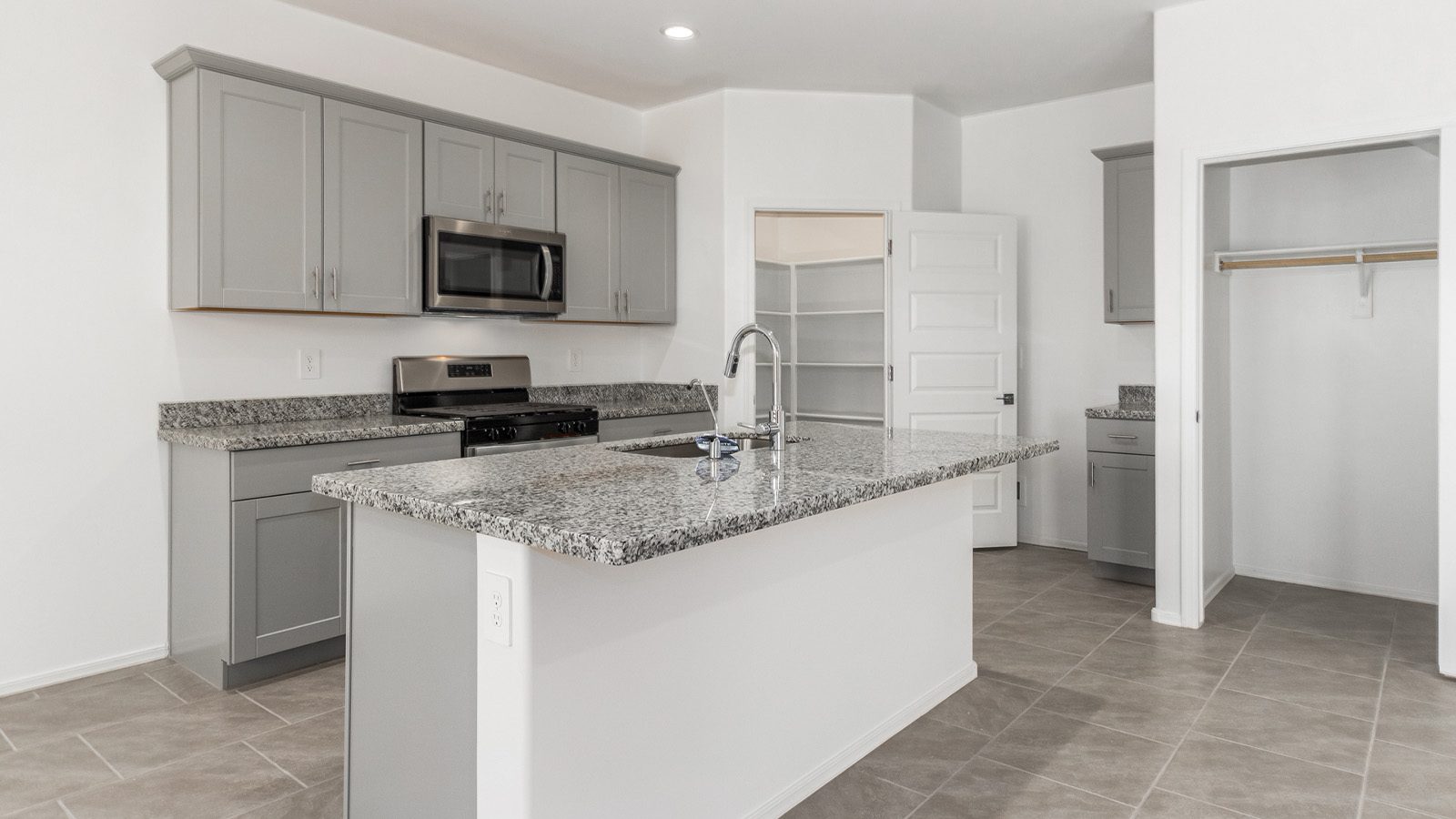 Introducing The Grace at Blackhawk in Tucson, Arizona – a spacious 1,963 sq. ft. two-story new home designed to accommodate modern living with style and functionality.  As you step through the welcoming front porch, you’re greeted by an open and inviting entryway that leads directly into the heart of the home. The main level features a spacious great room that flows seamlessly into the dining area and the modern kitchen, creating a perfect space for entertaining and family gatherings. The kitchen is equipped with elegant granite countertops, a large island with a breakfast bar, modern appliances, and a pantry that offers plenty of storage, making it as functional as it is stylish.  The main floor also includes a convenient powder room for guests, and direct access to the two-car garage, enhancing the home’s functionality and ease of living.  Heading upstairs, you'll discover the family’s private quarters. The master suite is a serene retreat, featuring a generously sized bedroom, a large walk-in closet, and an en-suite bathroom complete with dual vanities and a walk-in shower. The upper level also includes three additional bedrooms, a full bathroom, and a utility room conveniently located for easy access to all bedrooms. Additionally, a versatile loft area serves as a flexible space that can be used as a game room, home office, or even a second living area.  Back downstairs, step outside from the great room to the covered patio, where you can enjoy Tucson’s beautiful weather year-round. Whether you’re hosting an outdoor gathering or simply relaxing after a long day, this space extends your living area and enhances the home’s inviting ambiance.  Designed with energy efficiency in mind, The Grace at Blackhawk is a DOE Zero Energy Ready Home, ensuring sustainability, comfort, and long-term savings.