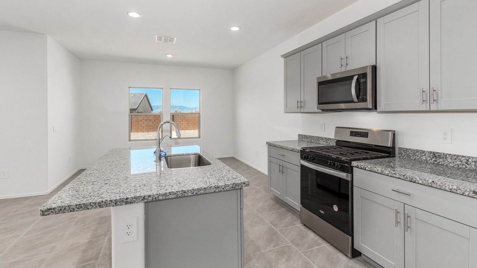 Introducing The Grace at Blackhawk in Tucson, Arizona – a spacious 1,963 sq. ft. two-story new home designed to accommodate modern living with style and functionality.  As you step through the welcoming front porch, you’re greeted by an open and inviting entryway that leads directly into the heart of the home. The main level features a spacious great room that flows seamlessly into the dining area and the modern kitchen, creating a perfect space for entertaining and family gatherings. The kitchen is equipped with elegant granite countertops, a large island with a breakfast bar, modern appliances, and a pantry that offers plenty of storage, making it as functional as it is stylish.  The main floor also includes a convenient powder room for guests, and direct access to the two-car garage, enhancing the home’s functionality and ease of living.  Heading upstairs, you'll discover the family’s private quarters. The master suite is a serene retreat, featuring a generously sized bedroom, a large walk-in closet, and an en-suite bathroom complete with dual vanities and a walk-in shower. The upper level also includes three additional bedrooms, a full bathroom, and a utility room conveniently located for easy access to all bedrooms. Additionally, a versatile loft area serves as a flexible space that can be used as a game room, home office, or even a second living area.  Back downstairs, step outside from the great room to the covered patio, where you can enjoy Tucson’s beautiful weather year-round. Whether you’re hosting an outdoor gathering or simply relaxing after a long day, this space extends your living area and enhances the home’s inviting ambiance.  Designed with energy efficiency in mind, The Grace at Blackhawk is a DOE Zero Energy Ready Home, ensuring sustainability, comfort, and long-term savings.