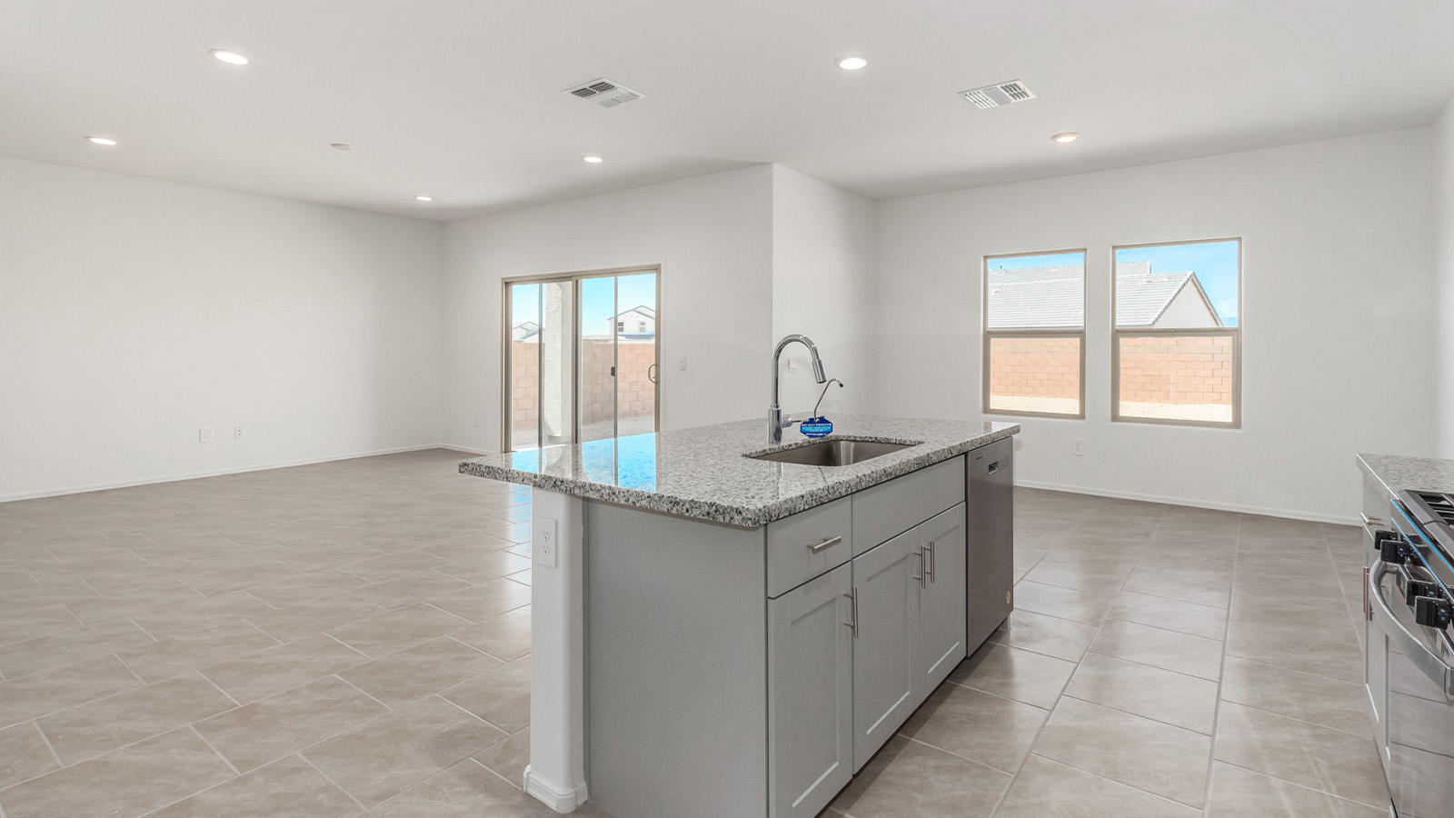 Introducing The Grace at Blackhawk in Tucson, Arizona – a spacious 1,963 sq. ft. two-story new home designed to accommodate modern living with style and functionality.  As you step through the welcoming front porch, you’re greeted by an open and inviting entryway that leads directly into the heart of the home. The main level features a spacious great room that flows seamlessly into the dining area and the modern kitchen, creating a perfect space for entertaining and family gatherings. The kitchen is equipped with elegant granite countertops, a large island with a breakfast bar, modern appliances, and a pantry that offers plenty of storage, making it as functional as it is stylish.  The main floor also includes a convenient powder room for guests, and direct access to the two-car garage, enhancing the home’s functionality and ease of living.  Heading upstairs, you'll discover the family’s private quarters. The master suite is a serene retreat, featuring a generously sized bedroom, a large walk-in closet, and an en-suite bathroom complete with dual vanities and a walk-in shower. The upper level also includes three additional bedrooms, a full bathroom, and a utility room conveniently located for easy access to all bedrooms. Additionally, a versatile loft area serves as a flexible space that can be used as a game room, home office, or even a second living area.  Back downstairs, step outside from the great room to the covered patio, where you can enjoy Tucson’s beautiful weather year-round. Whether you’re hosting an outdoor gathering or simply relaxing after a long day, this space extends your living area and enhances the home’s inviting ambiance.  Designed with energy efficiency in mind, The Grace at Blackhawk is a DOE Zero Energy Ready Home, ensuring sustainability, comfort, and long-term savings.