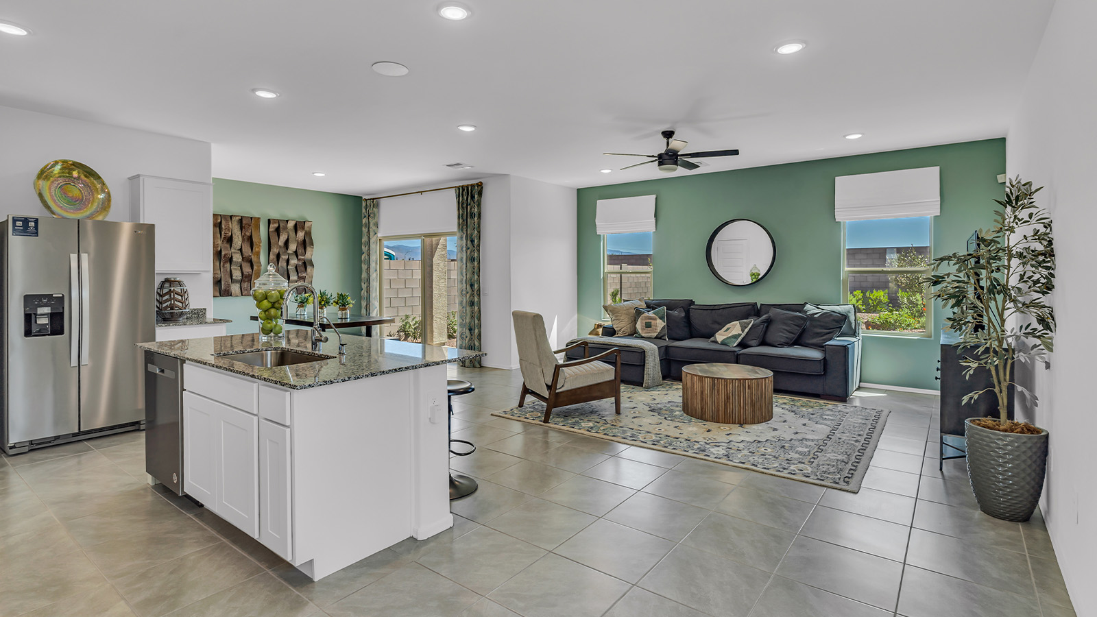 Introducing The Kate at Blackhawk in Tucson, Arizona – a spacious 2,264 sq. ft. two-story new home designed to offer both comfort and modern living in a prime location.  As you step through the inviting front porch, you’re welcomed into a thoughtfully designed entryway that leads directly into the heart of the home. The main floor boasts a generous great room that seamlessly connects to the dining area and kitchen, creating an ideal space for entertaining and everyday living. The kitchen is equipped with sleek granite countertops, a large island with a breakfast bar, modern appliances, and a pantry that provides ample storage, ensuring that the kitchen is both functional and stylish.  The main level also features a convenient powder room, perfect for guests, and direct access to the two-car garage, enhancing the home’s practicality.  Heading upstairs, you’ll discover the family’s private quarters. The master suite offers a serene retreat, complete with a spacious bedroom, a large walk-in closet, and an en-suite bathroom featuring dual vanities and a walk-in shower. The upper level also includes three additional bedrooms, a full bathroom, and a utility room centrally located for easy access. Additionally, a versatile loft area provides extra space that can be tailored to fit your lifestyle, whether as a game room, home office, or a second living area.  Step outside from the great room to the covered patio, where you can enjoy Tucson’s beautiful weather year-round. Whether you’re hosting an outdoor gathering or simply relaxing after a long day, this space extends your living area and enhances the home’s inviting ambiance.  Designed with energy efficiency in mind, The Kate at Blackhawk is a DOE Zero Energy Ready Home, combining sustainability, comfort, and long-term savings.